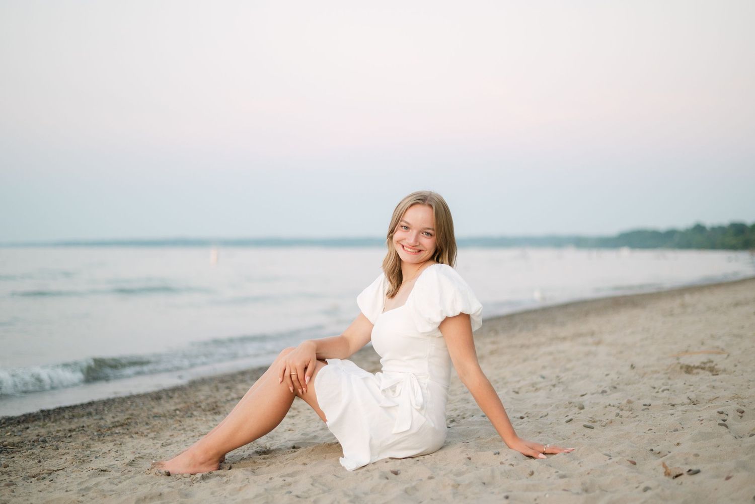 Girl smiling relaxed on the beach at sunset