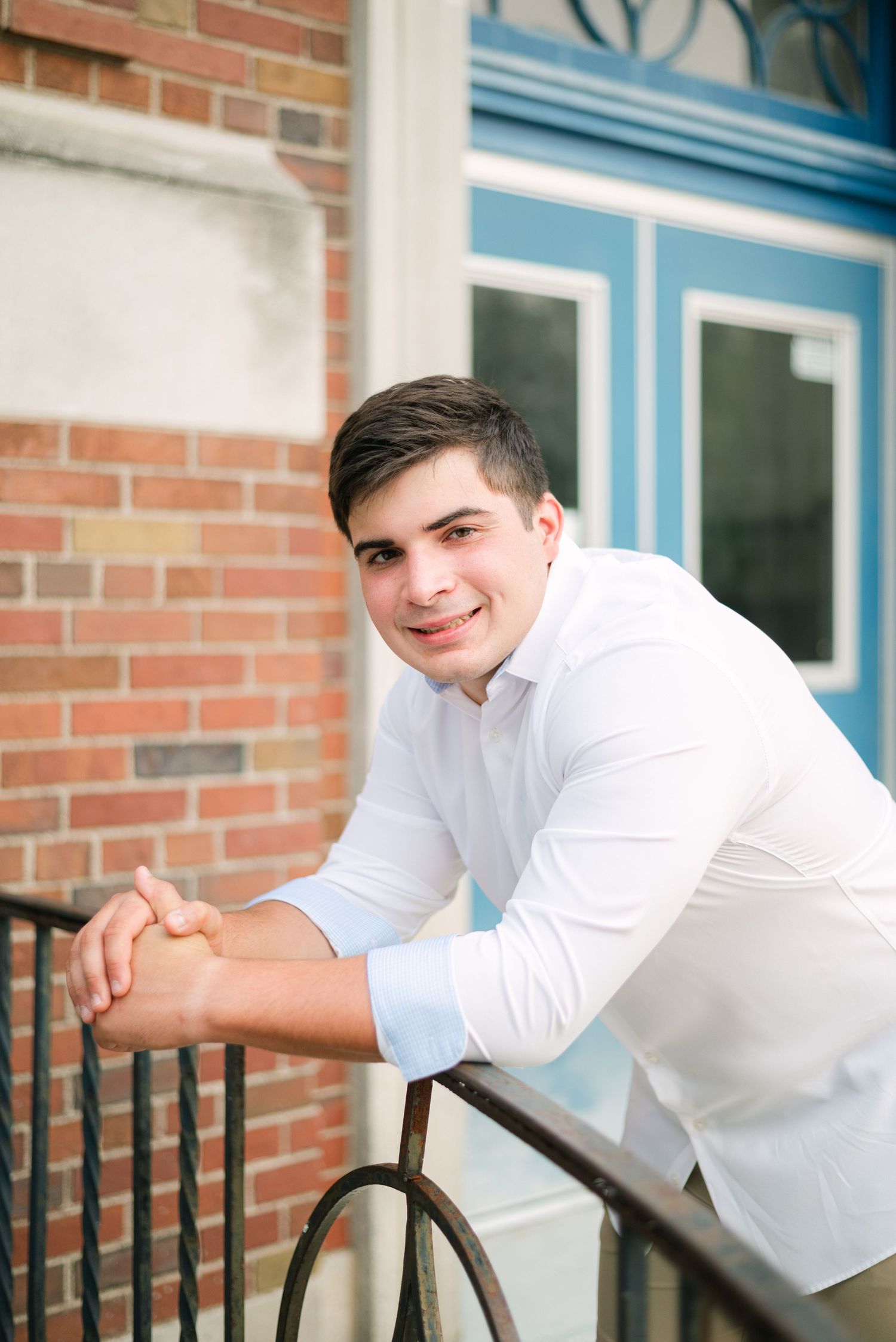 Boy smiling leaning over railing