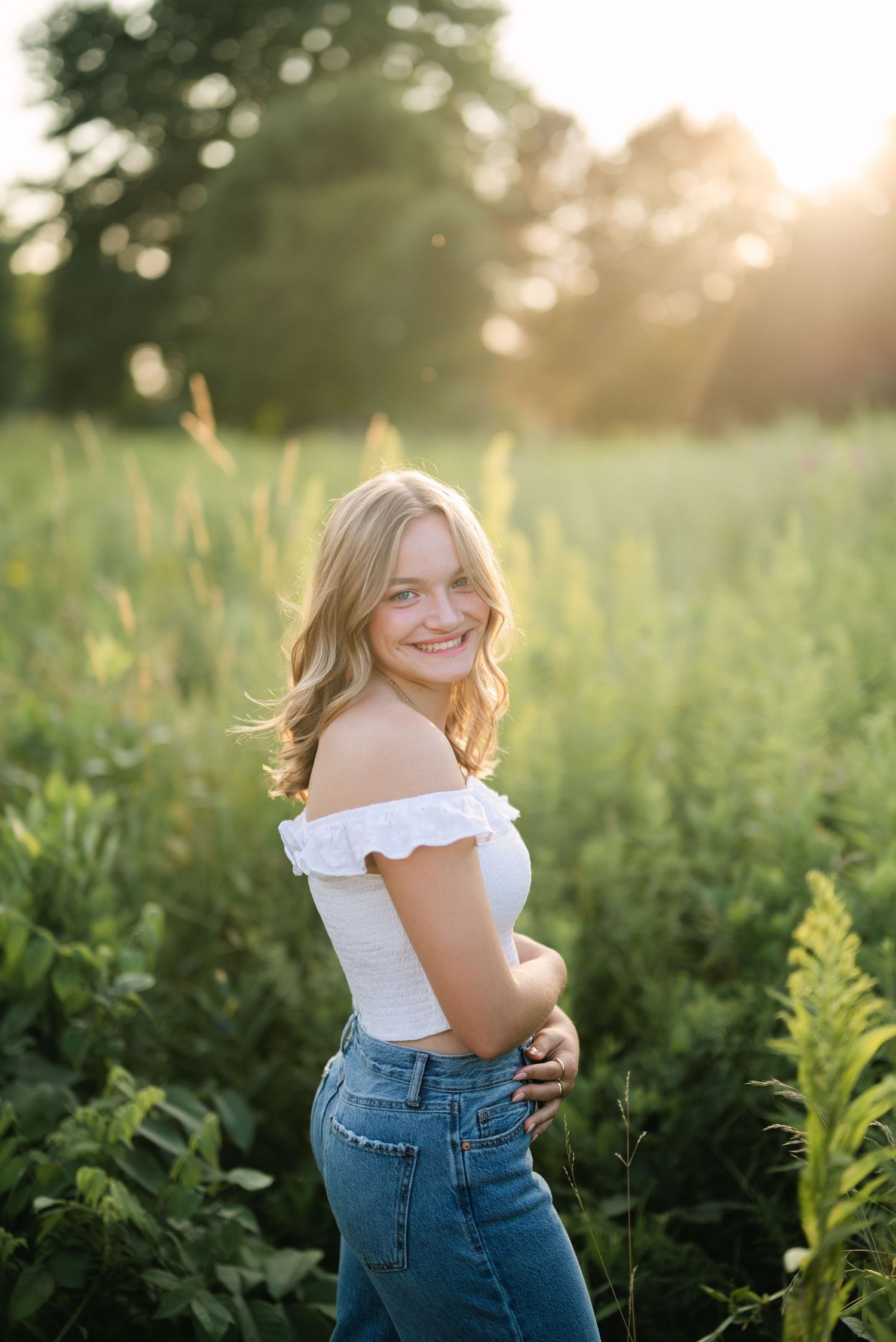 Blonde girl smiling in a field of flowers