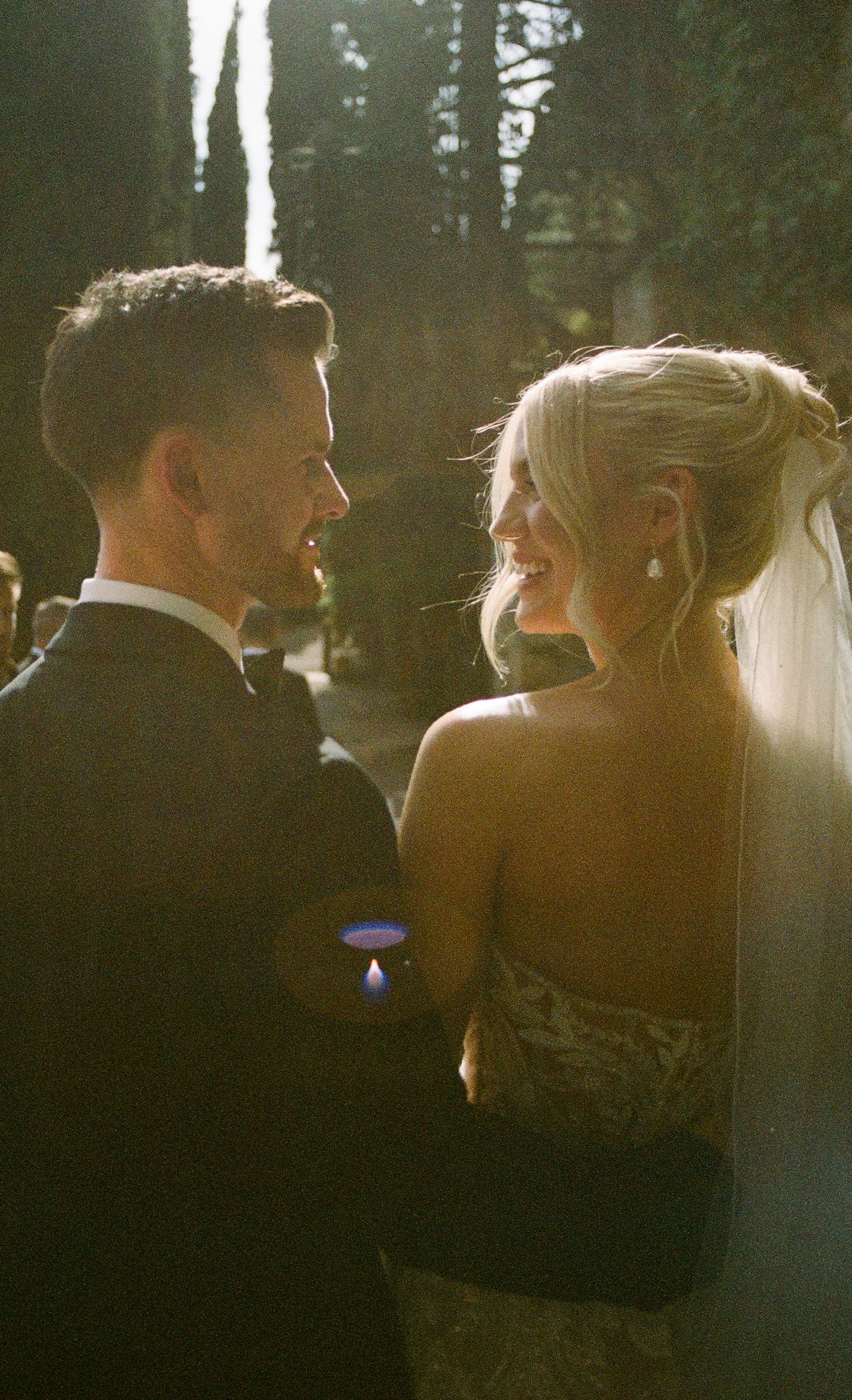 A romantic moment captured in golden sunlight between newlyweds.