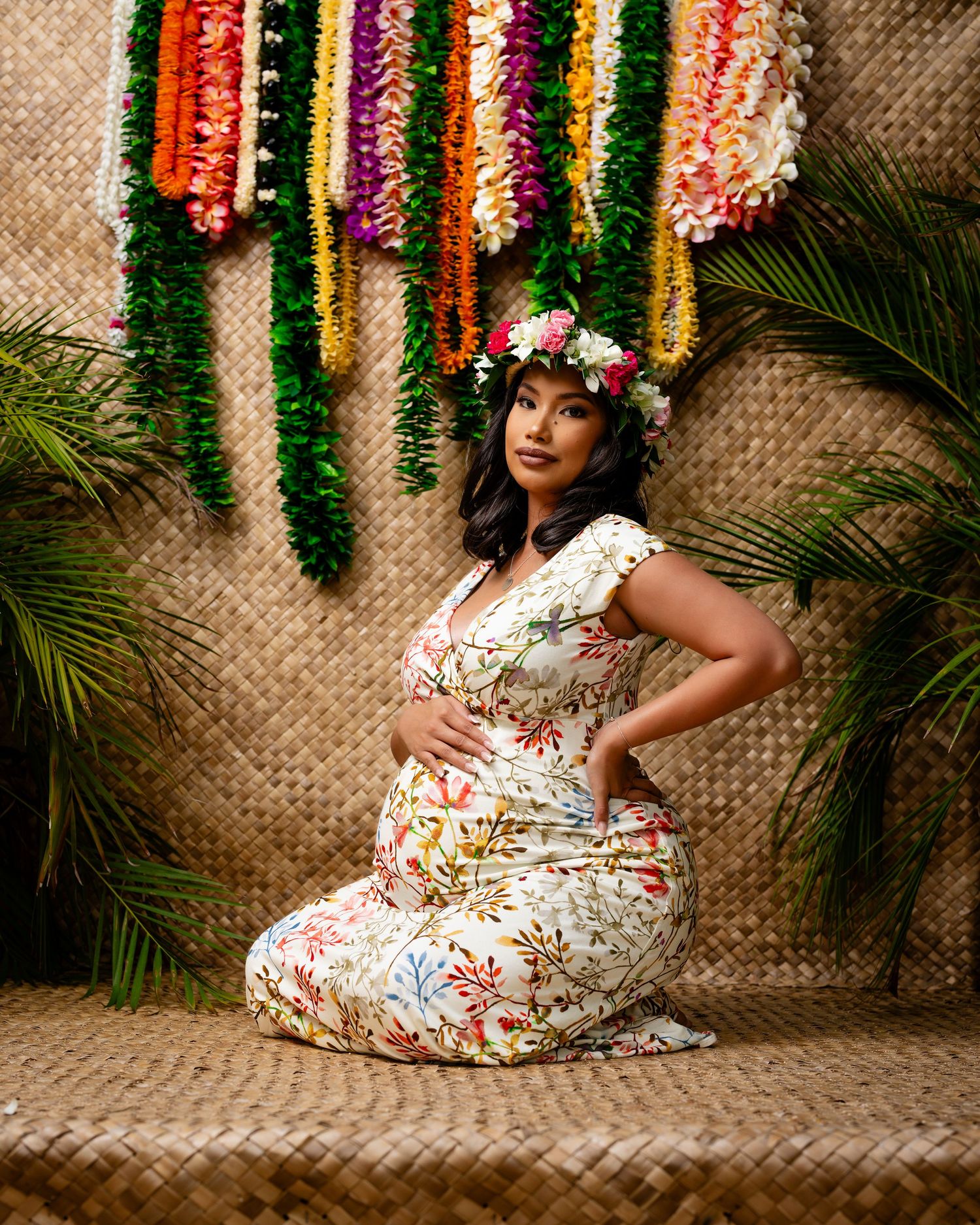 Colorful floral garlands decorating tropical themed backdrop.