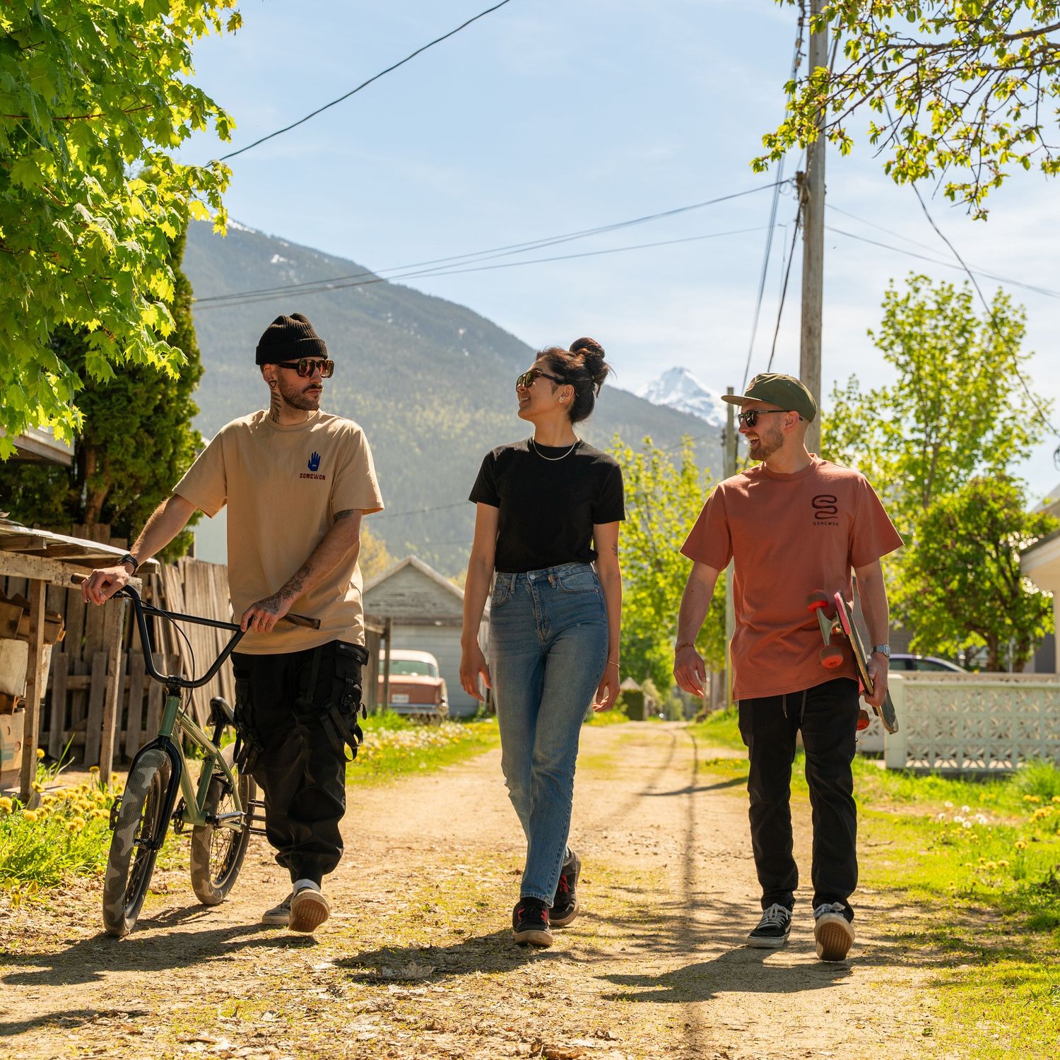 Candid moment of friends hiking a Revelstoke trail during golden hour