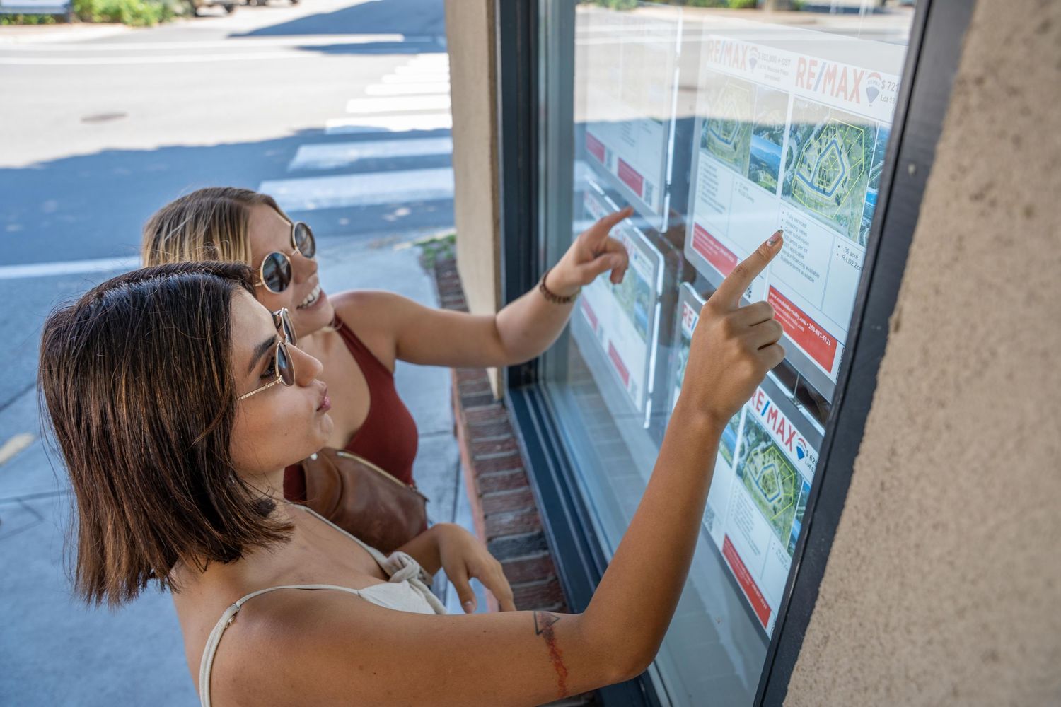 Remax revelstoke realty photo girls viewing real estate listings Revelstoke drone photography, aerial videography Revelstoke, drone footage