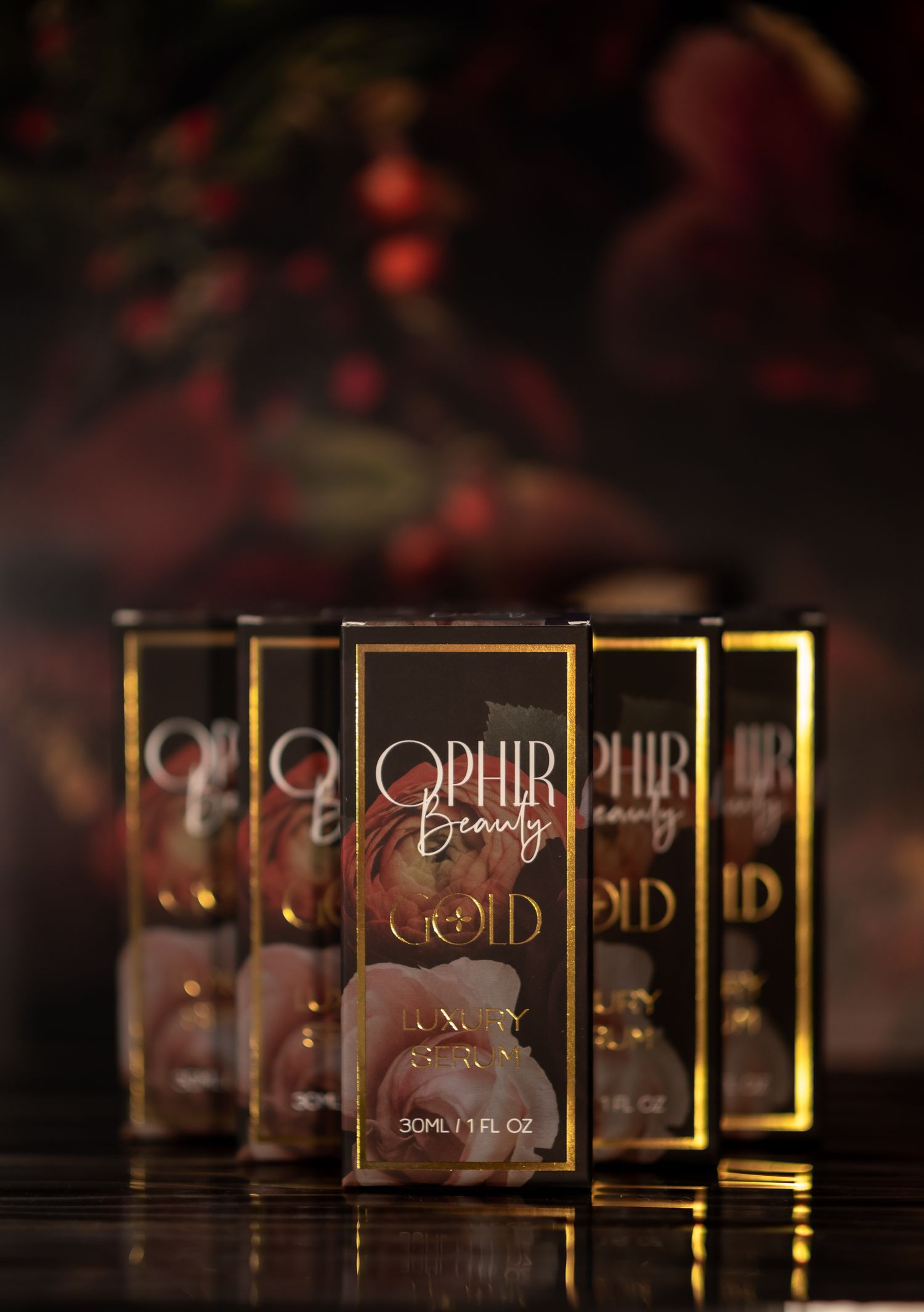 A precise arrangement of boxed Ophir Beauty gold serum boxes in a dark setting, with light reflecting off their gilded boxes