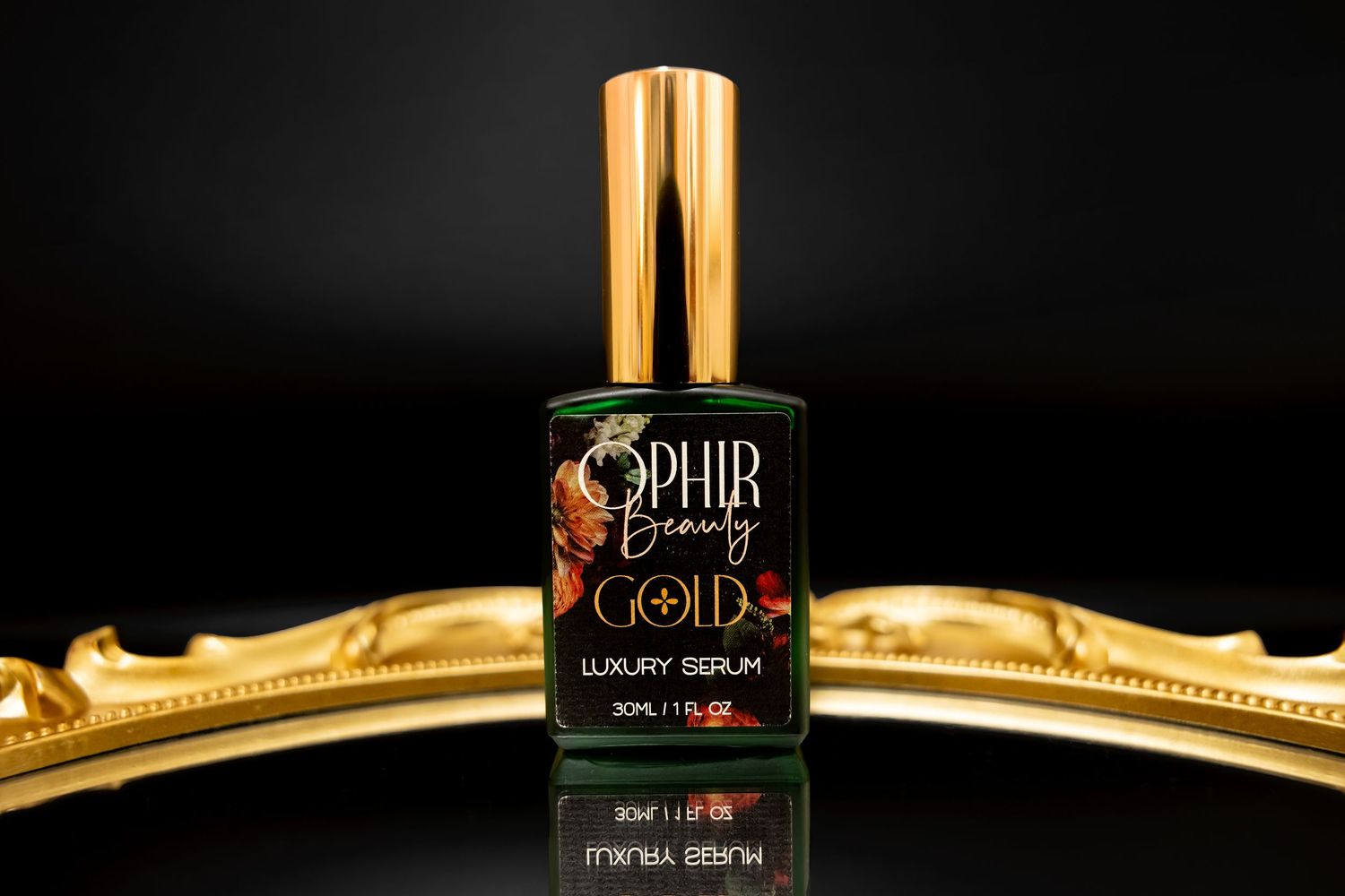 A single bottle of Ophir Gold stands on a mirrored tray against a black background