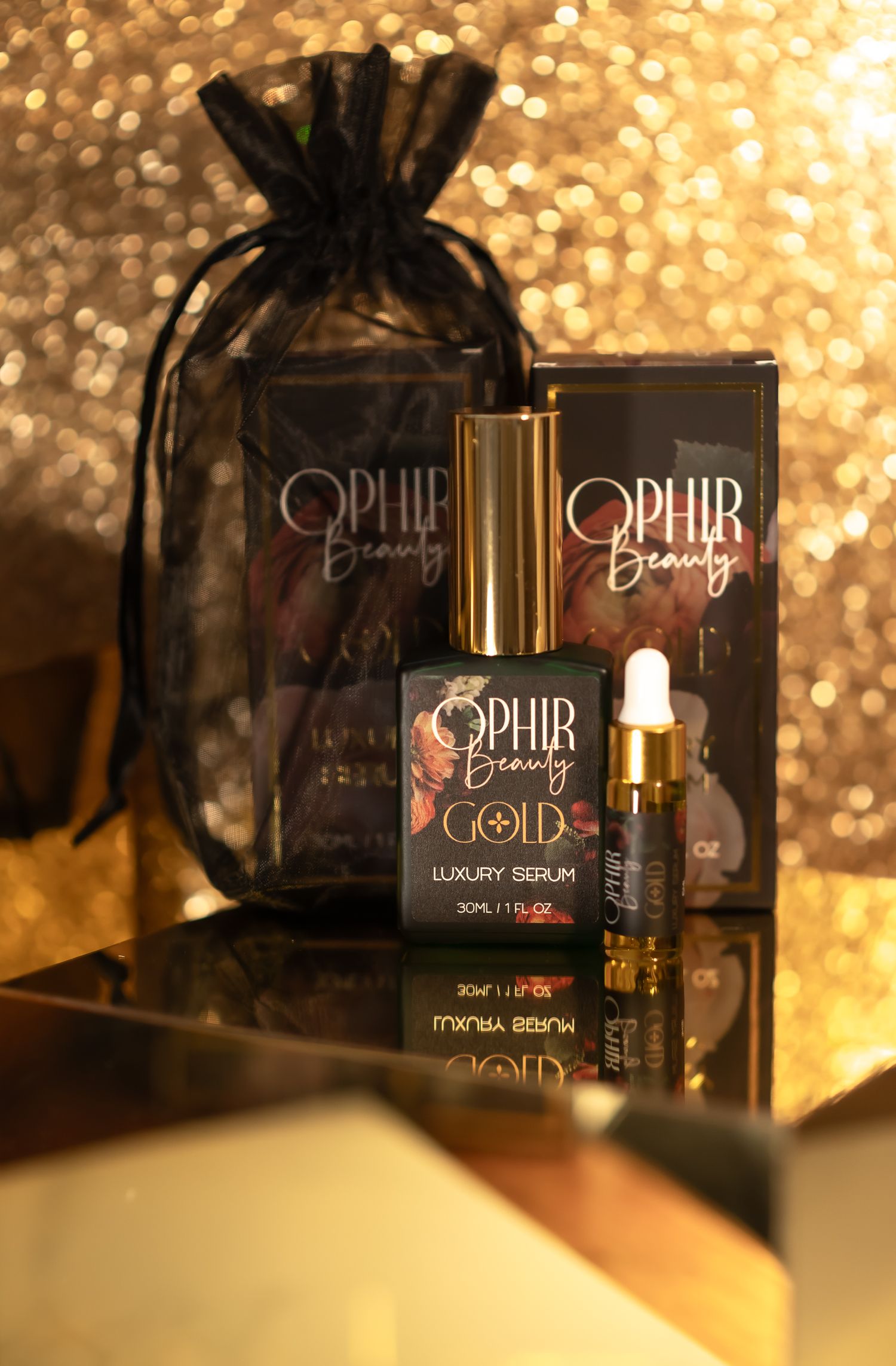 an arrangement of Ophir Beauty luxury Gold serums on a glimmering gold surface with a gold glitter background
