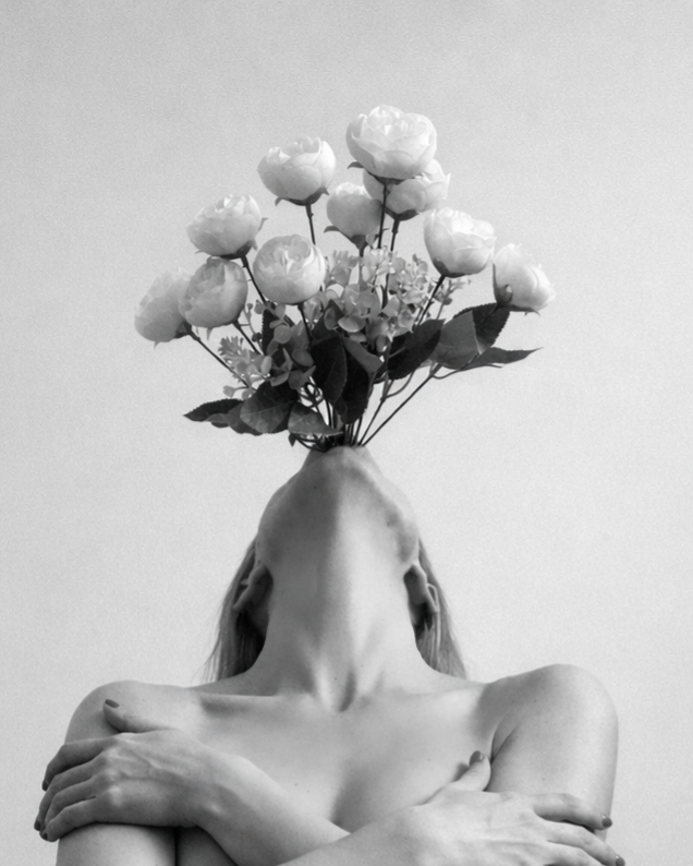 Black and white surreal portrait of a woman with arms crossed and head tilted back, a bouquet of roses replacing her face.