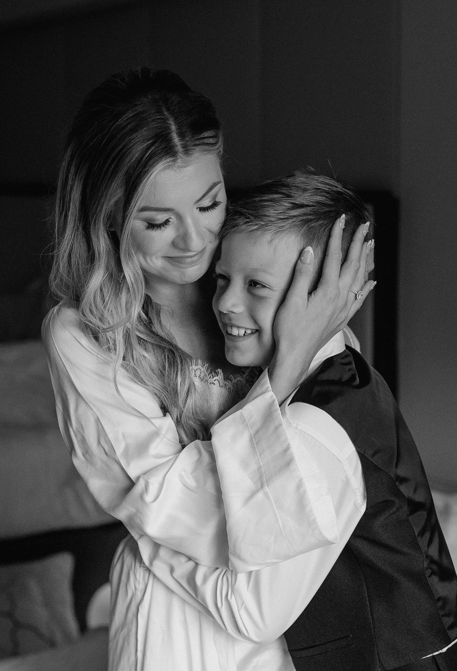 Intimate black and white portrait of a couple sharing a tender moment.
