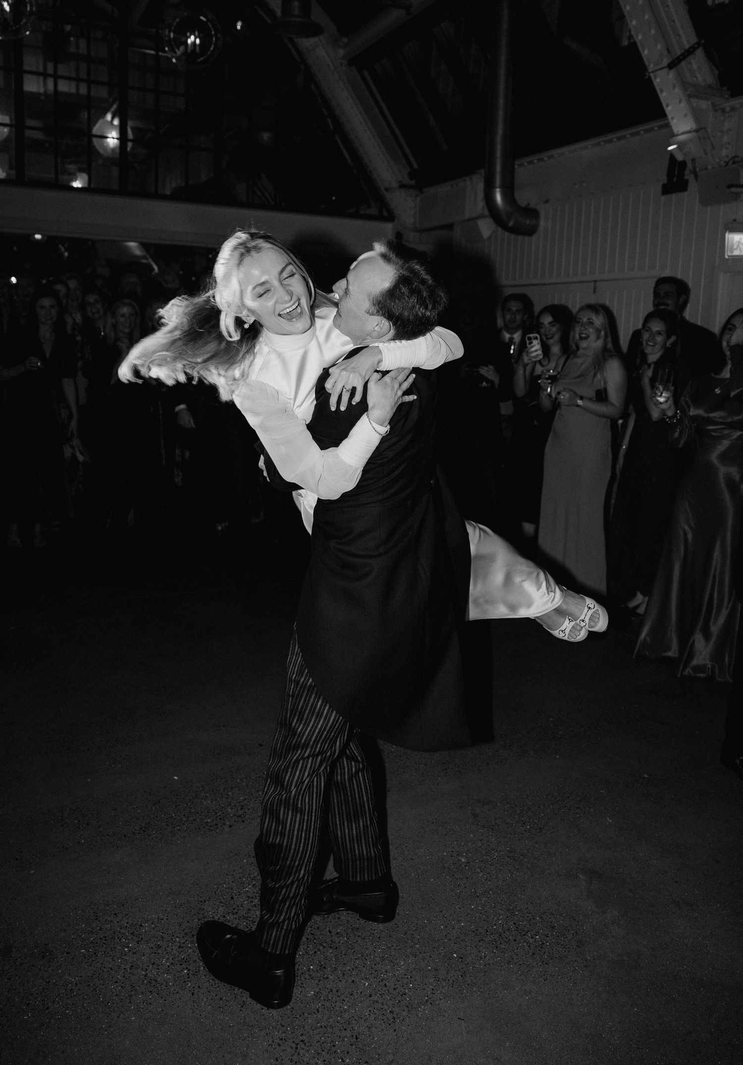 Black and white photos show energetic swing dancing with dramatic lifts and spins on a dance floor.