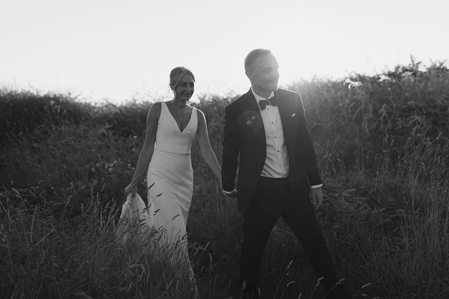 A black and white photo sequence showing silhouettes of people against a sunset in Guernsey