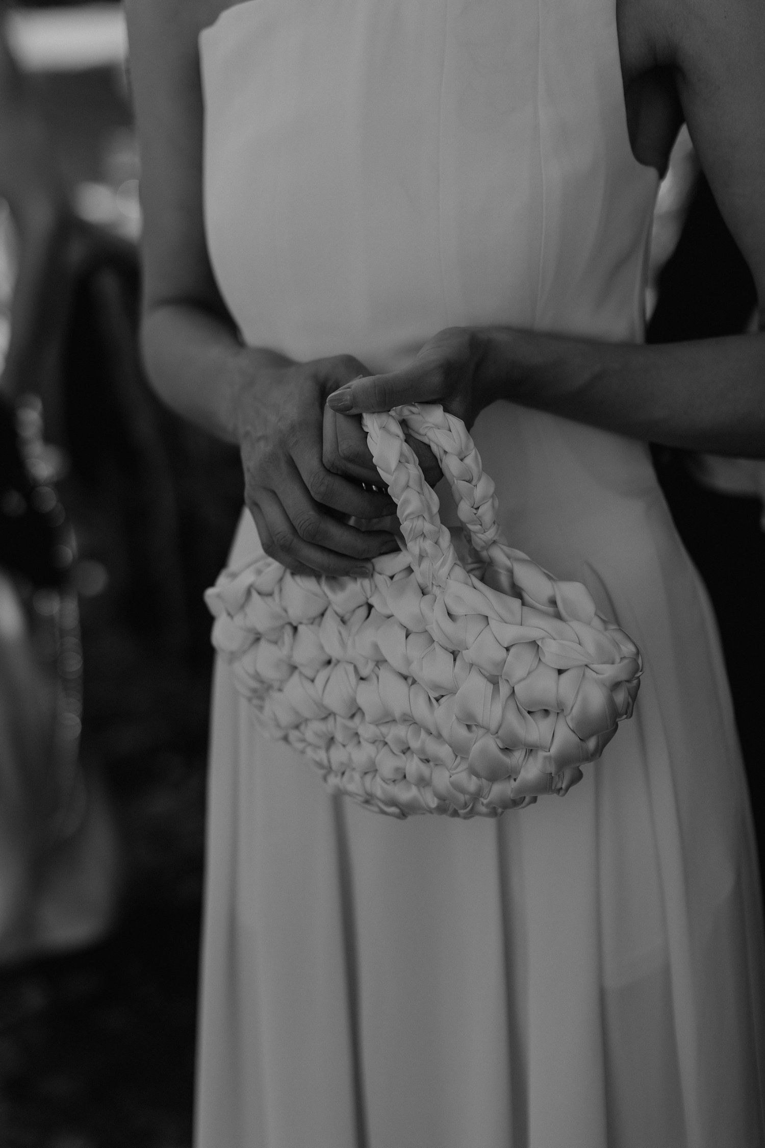 Close-up details of white ruffled fabric on a wedding dress waistline.