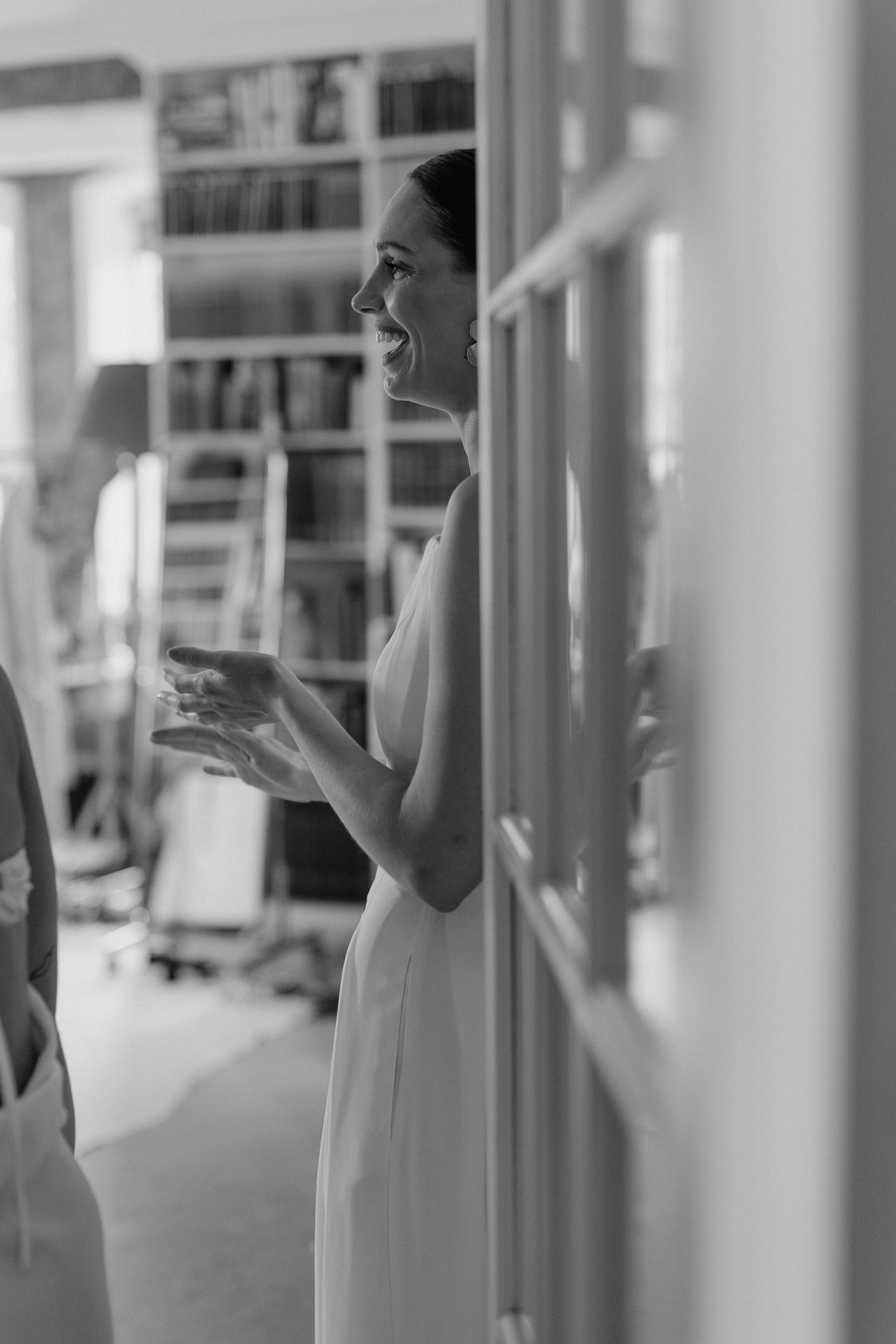 A black and white photo sequence showing hands gesturing through white pillars.
