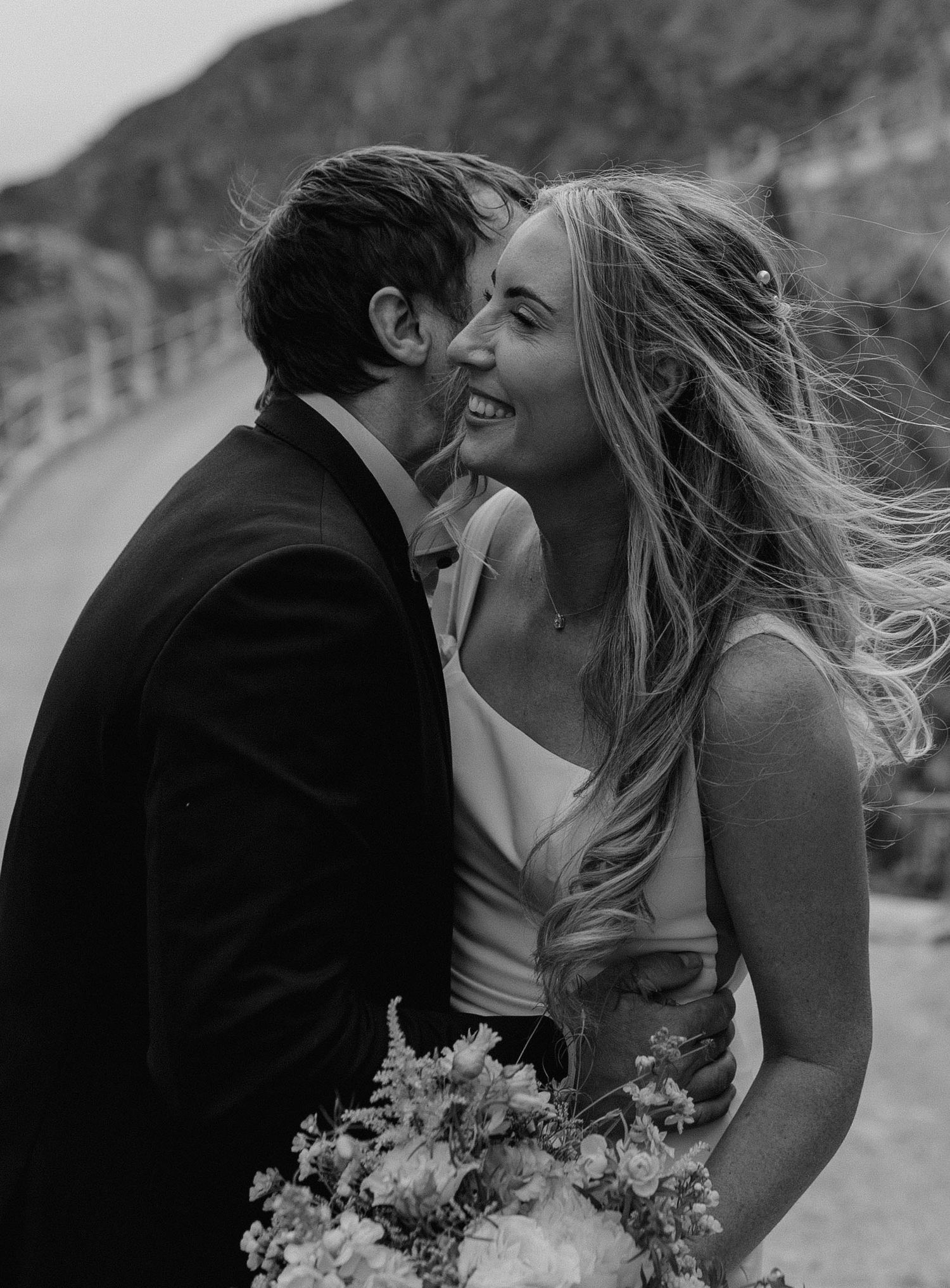 Black and white romantic sequence with wedding bouquet visible in foreground.