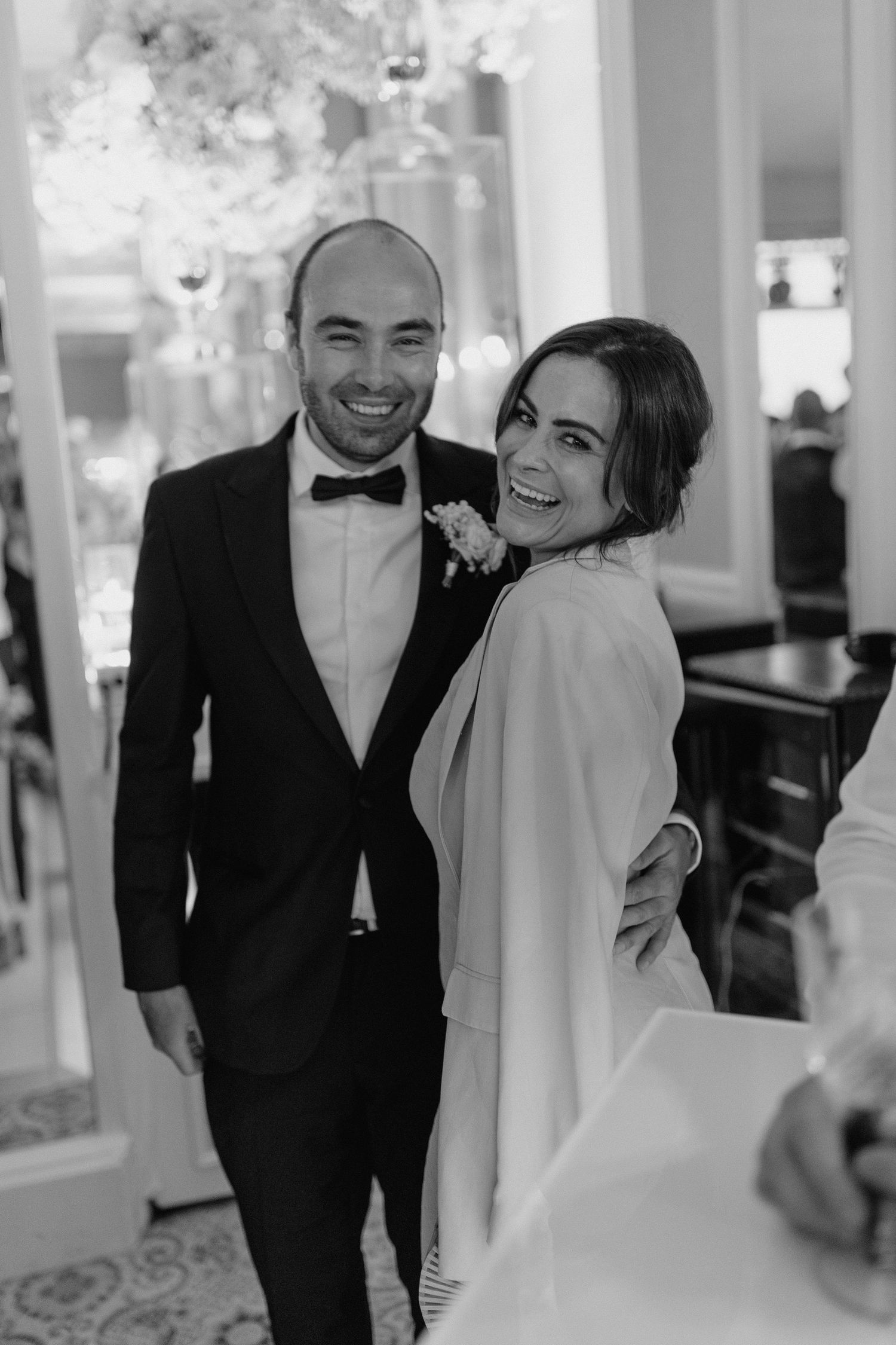 A joyful moment captured in black and white at an elegant indoor venue.