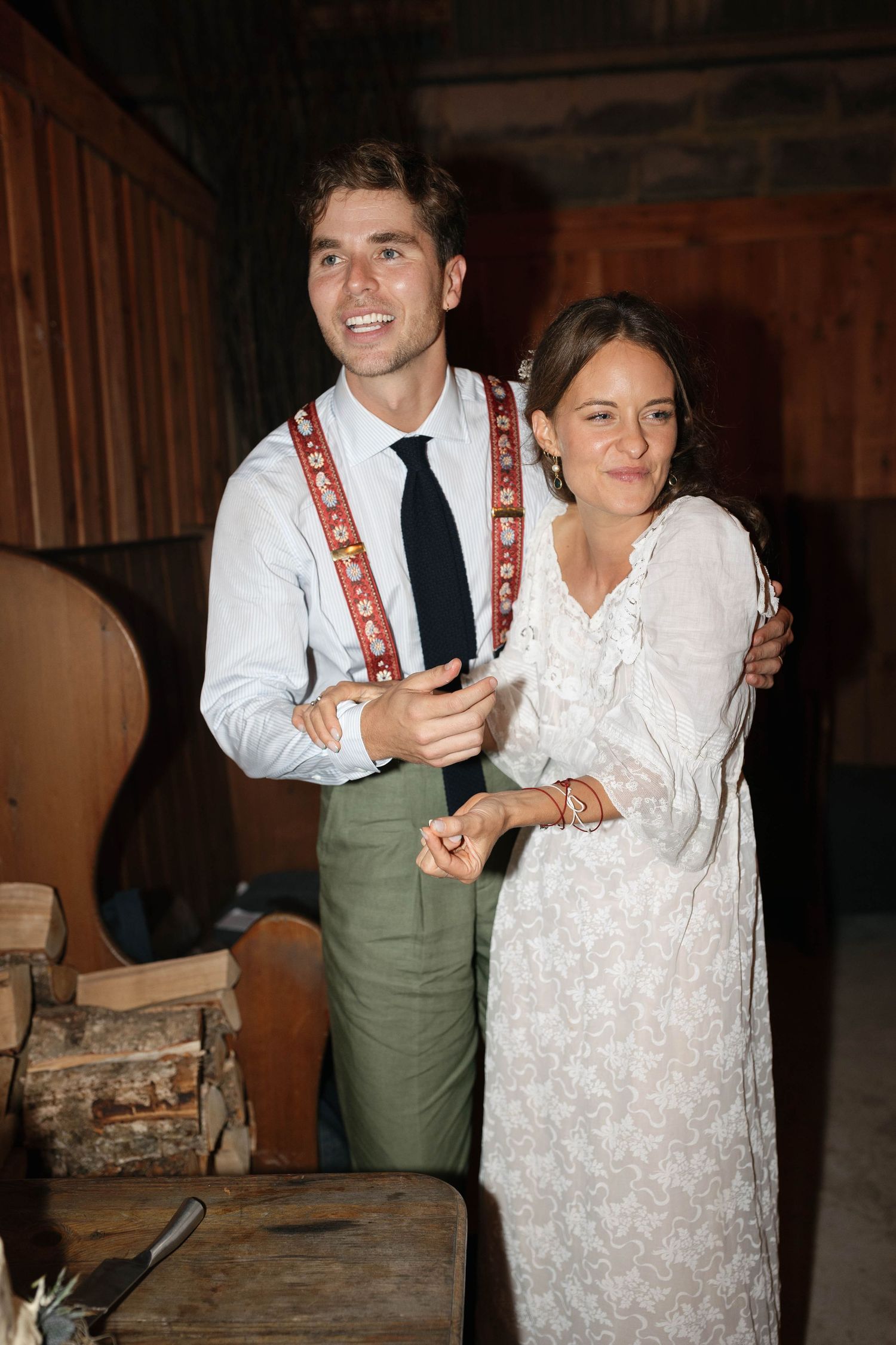 Wedding celebration candid moments in a rustic indoor setting with warm lighting.