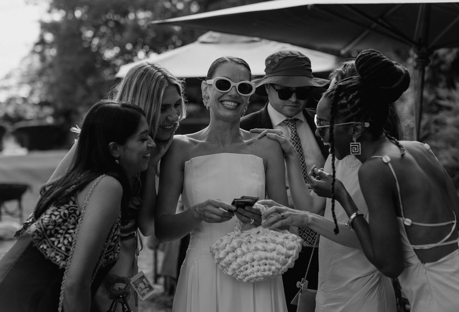 Wedding guests enjoying an outdoor celebration on a sunny day.