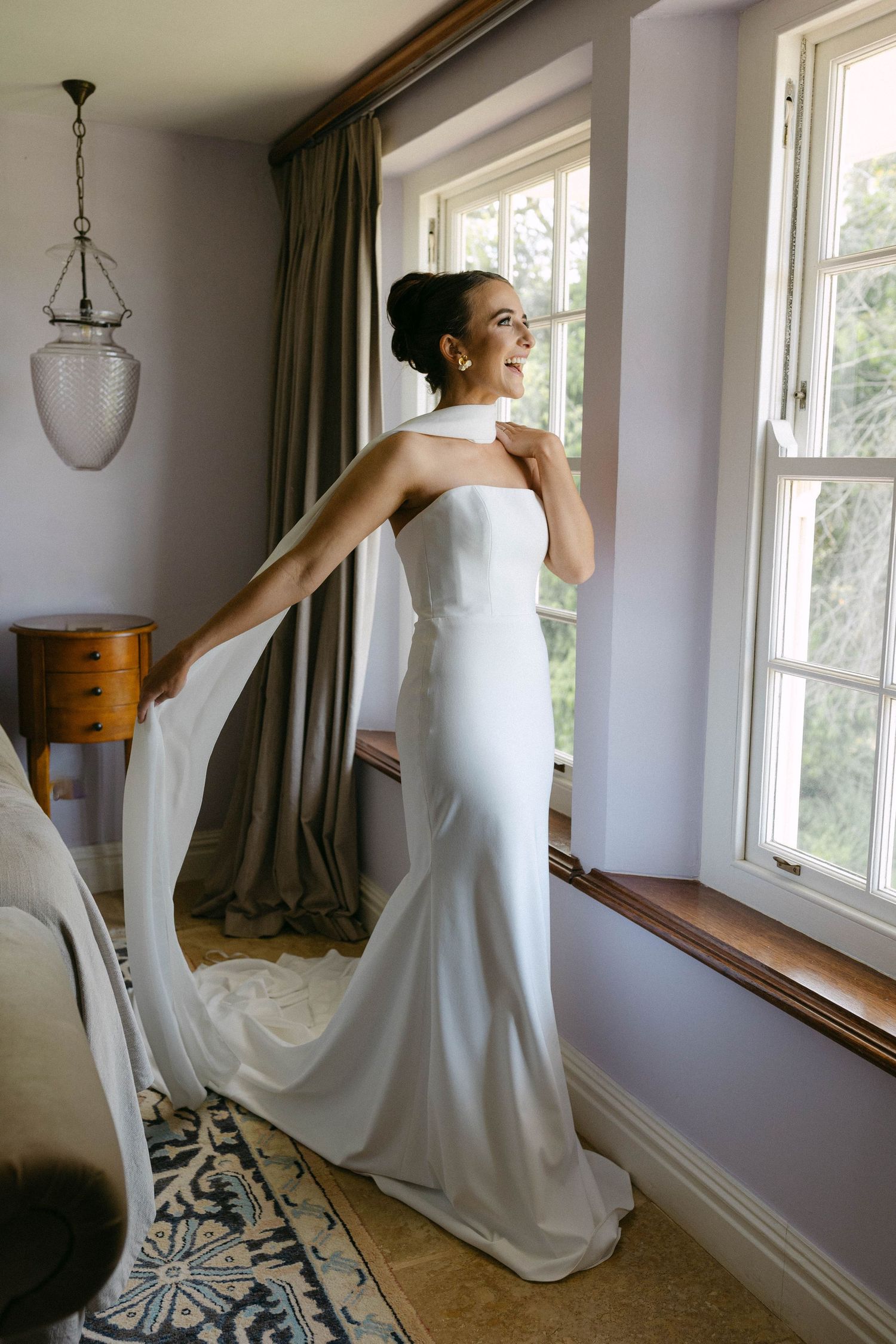 Sequence showing flowing white wedding dress movement in natural window light.