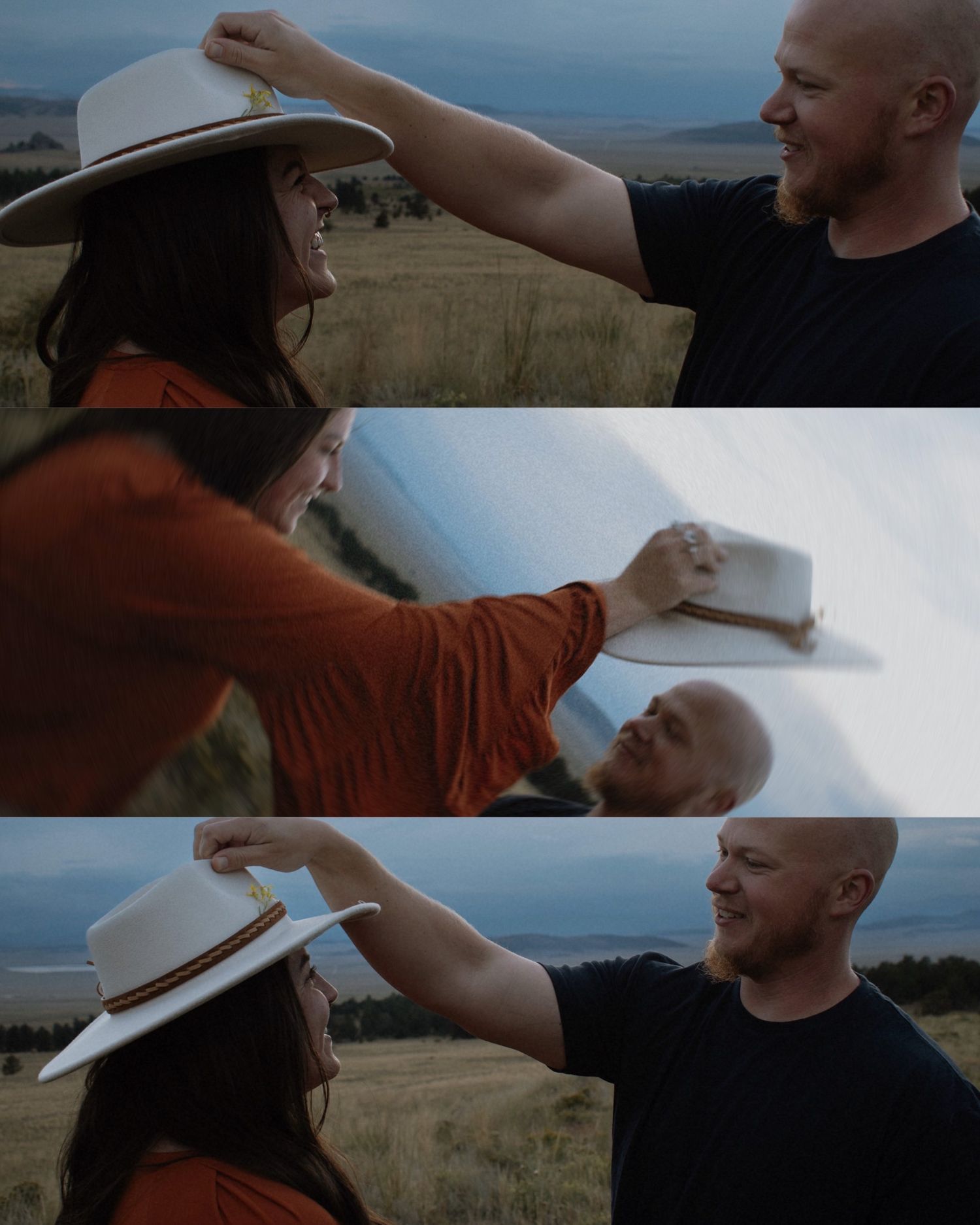 A woman in an orange top places a white hat on a smiling bald man outdoors in a golden field.