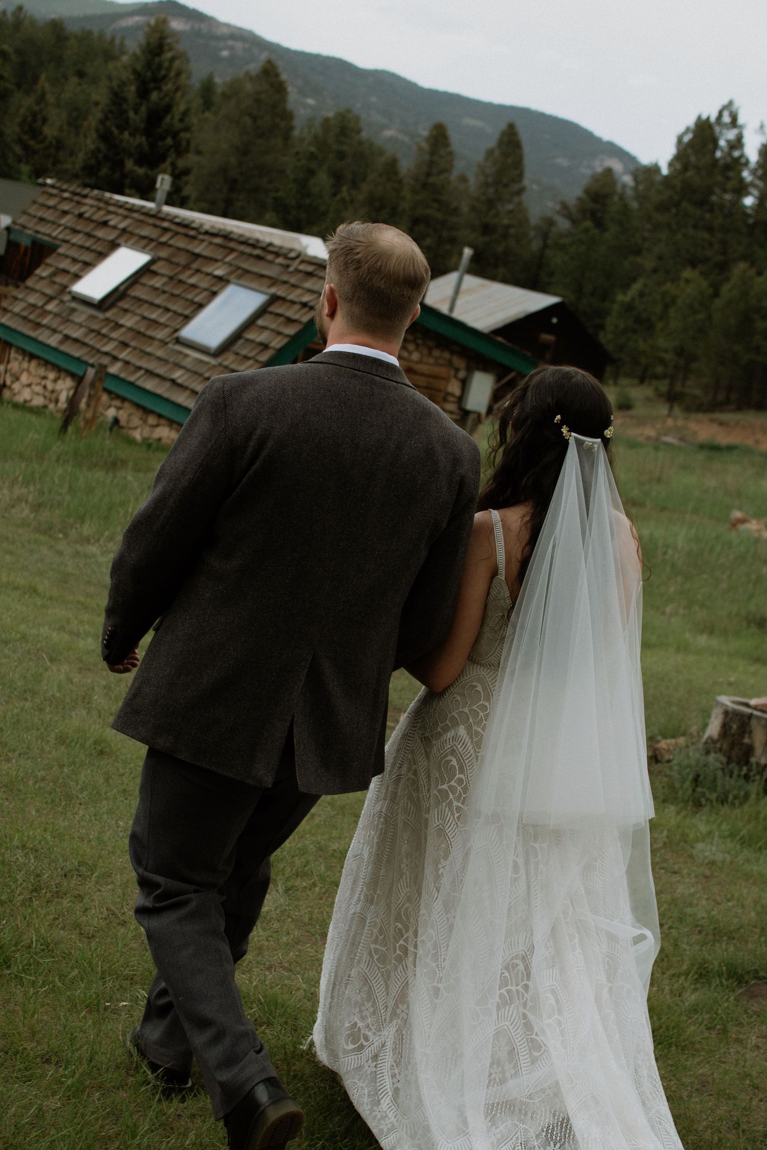 newly wed couple walking arm in arm back down the aisle first walk as husband and wife boho mountain vintage Colorado wedding photography