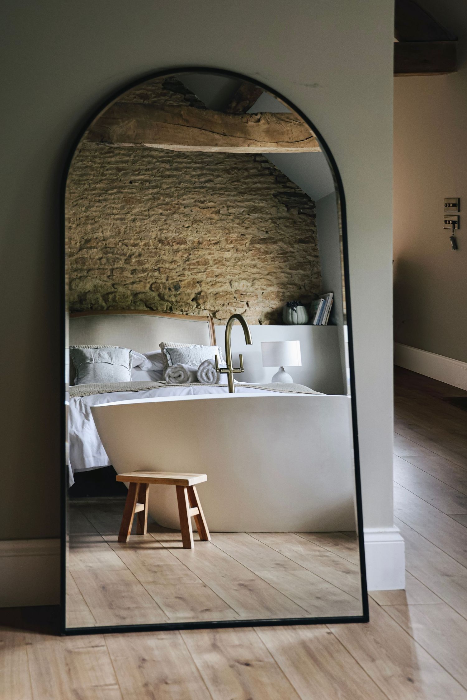 A mirror reflects the interior of a room at Churchfarm Estate in Wiltshire