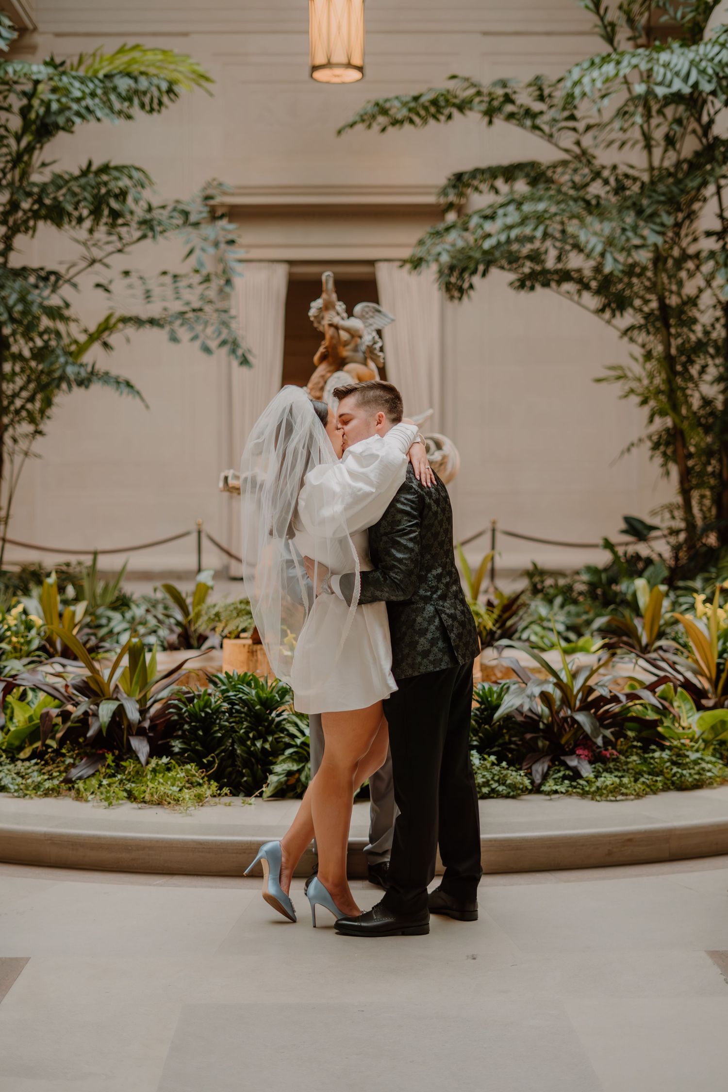 Bride and groom exchange first kiss at National Gallery of Art in Washington DC