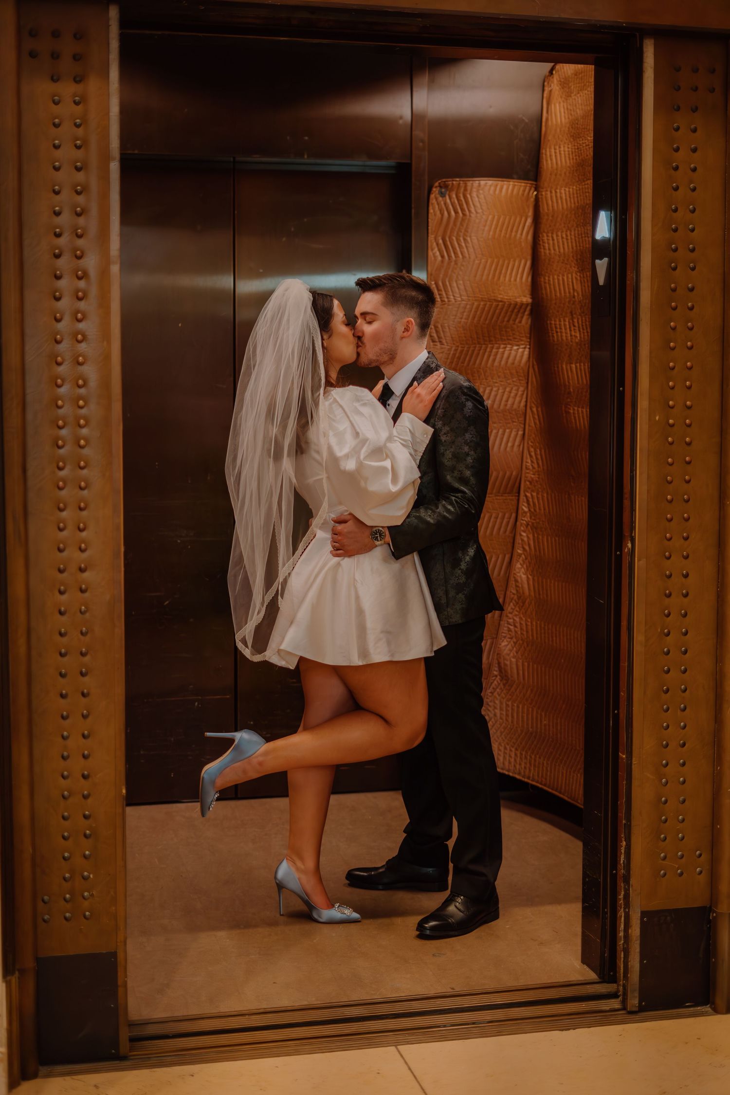 Bride and groom kissing in the elevator at the National Gallery of Art in Washington DC