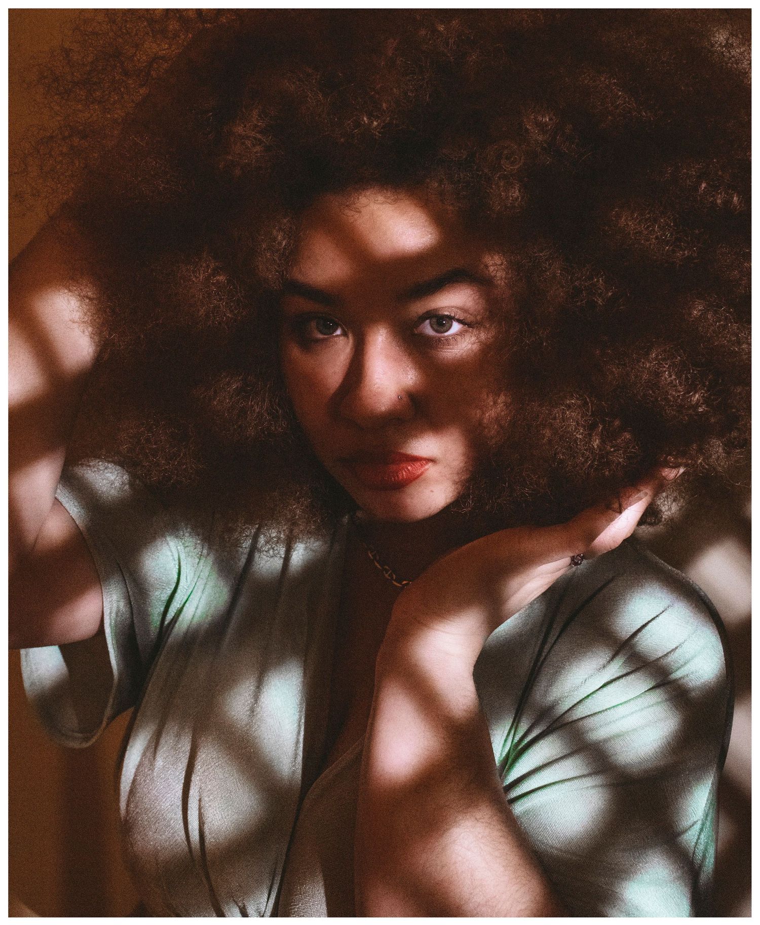 Artistic portrait with ethereal lighting and shadows creating a dreamy, atmospheric mood.