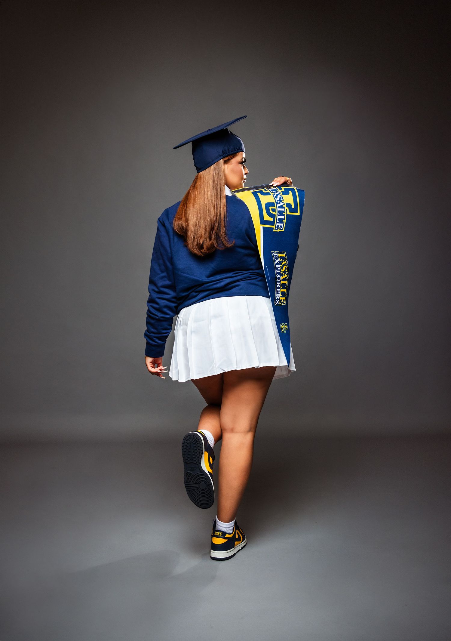 Athletic figure in blue jacket and sneakers poses from different angles showcasing sporty streetwear style against gray backdrop.