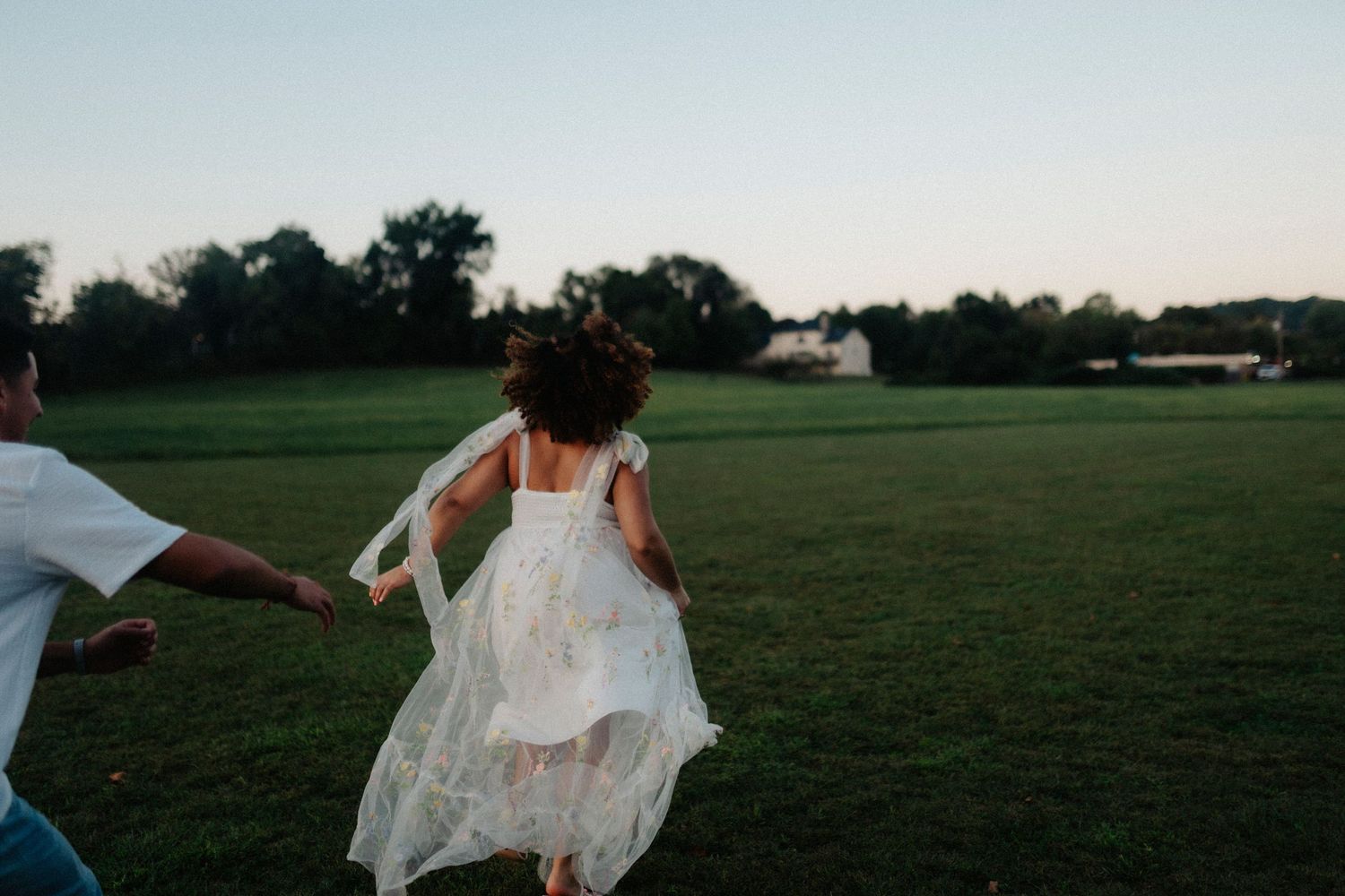 A series of photos showing a bride in a flowing white dress running through an open grassy field at sunset.