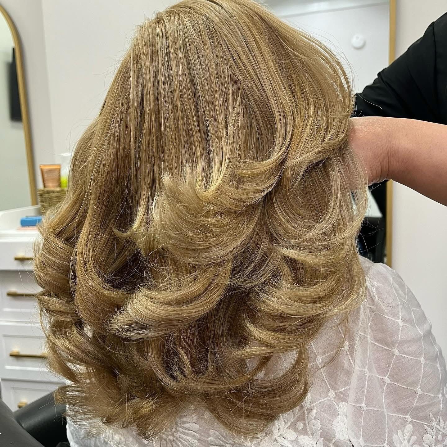 Close-up views of blonde layered hairstyle with soft waves and highlights from multiple angles.