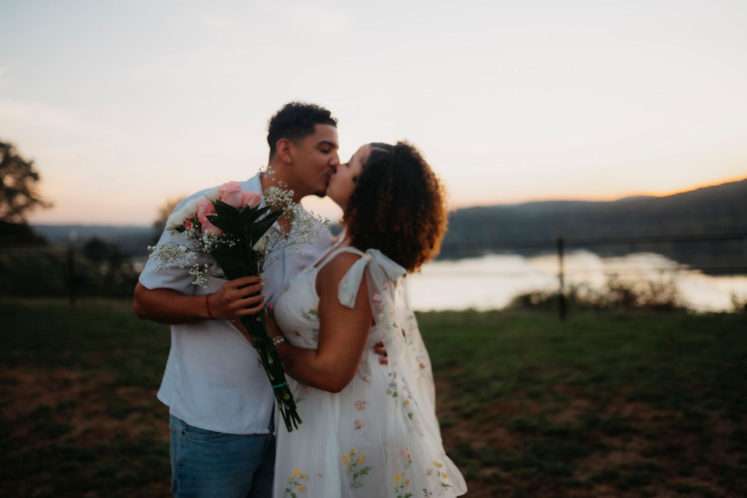 A romantic couple shares tender moments at sunset across multiple scenic outdoor locations near mountains and water.