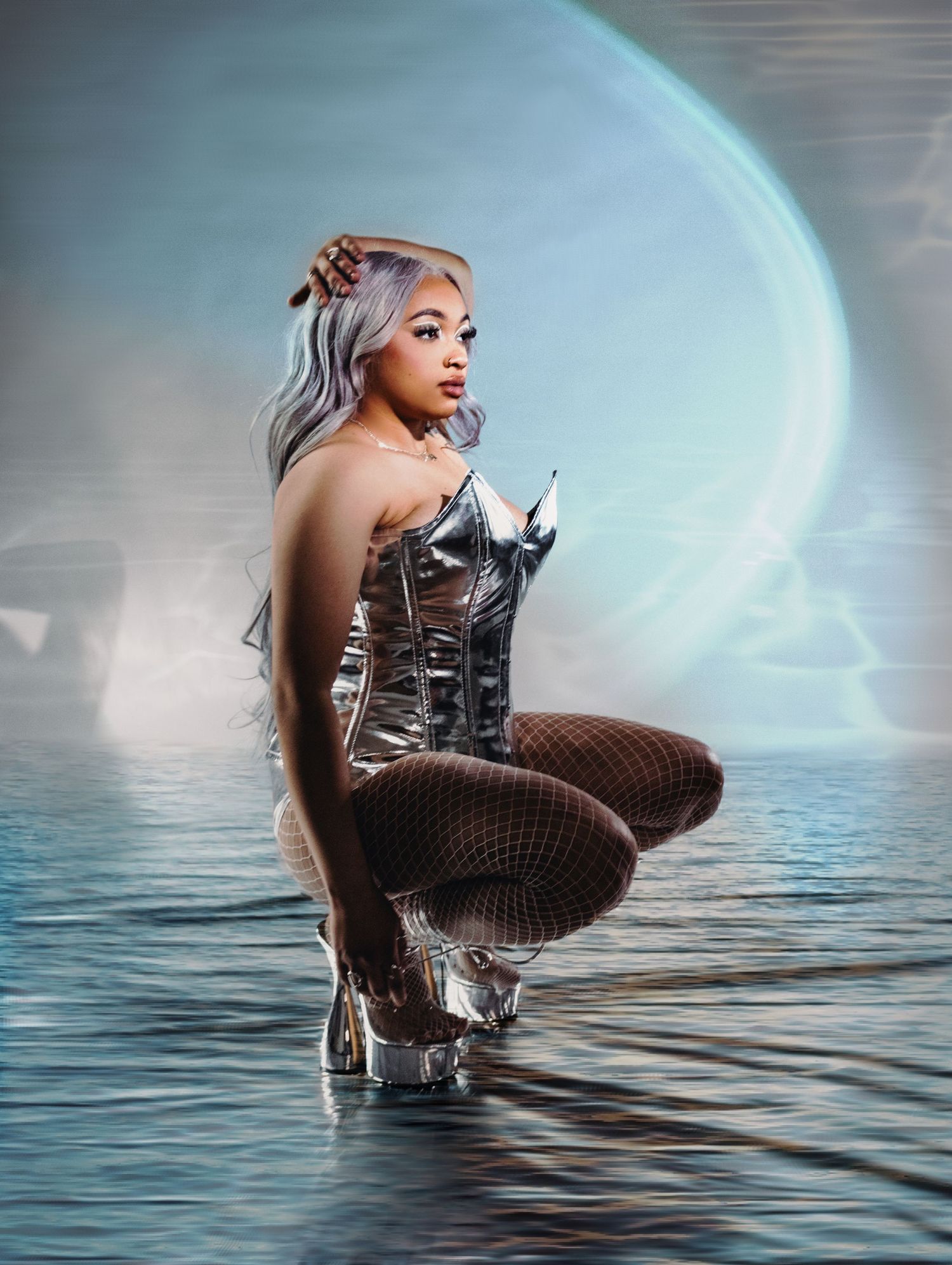 Fantasy photo of model in silver corset posed in water with ethereal lighting.