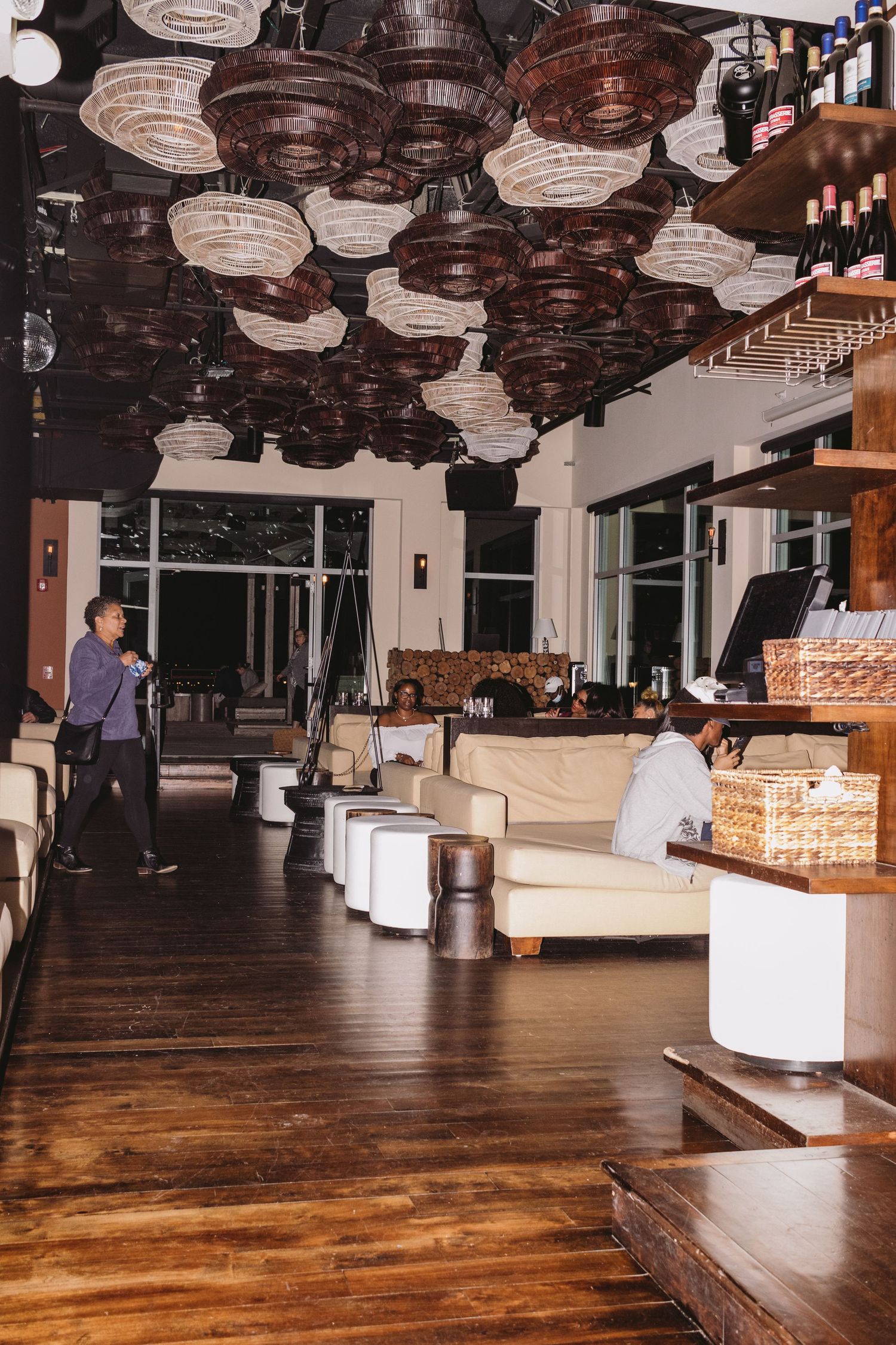 Modern event space with wooden floors and paper lantern ceiling lights creating an elegant atmosphere.