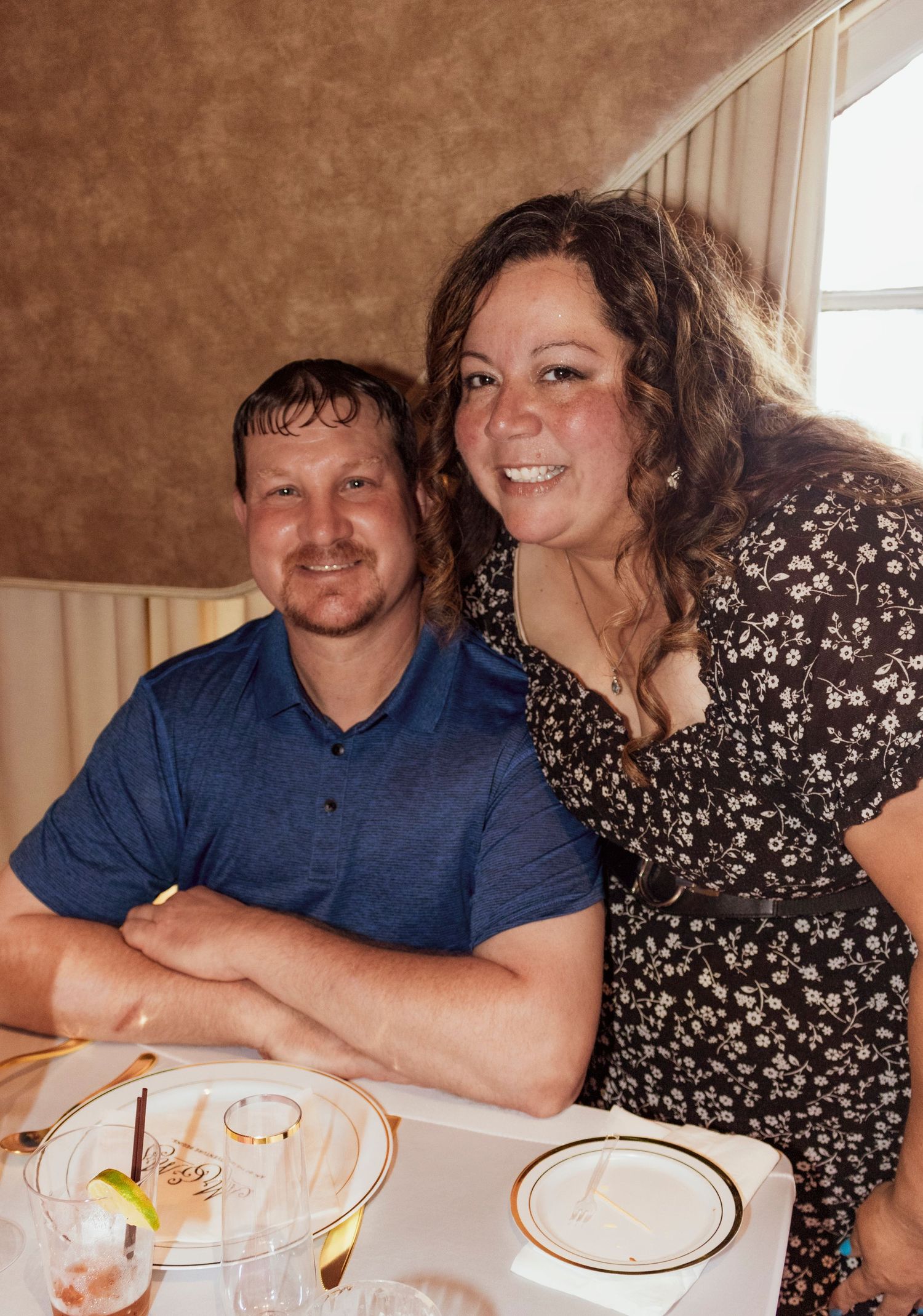 Couple sitting together at a dining table during a special event.
