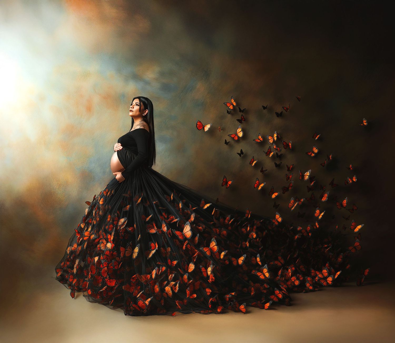 A dramatic black gown dissolving into orange butterflies against a moody dark background.