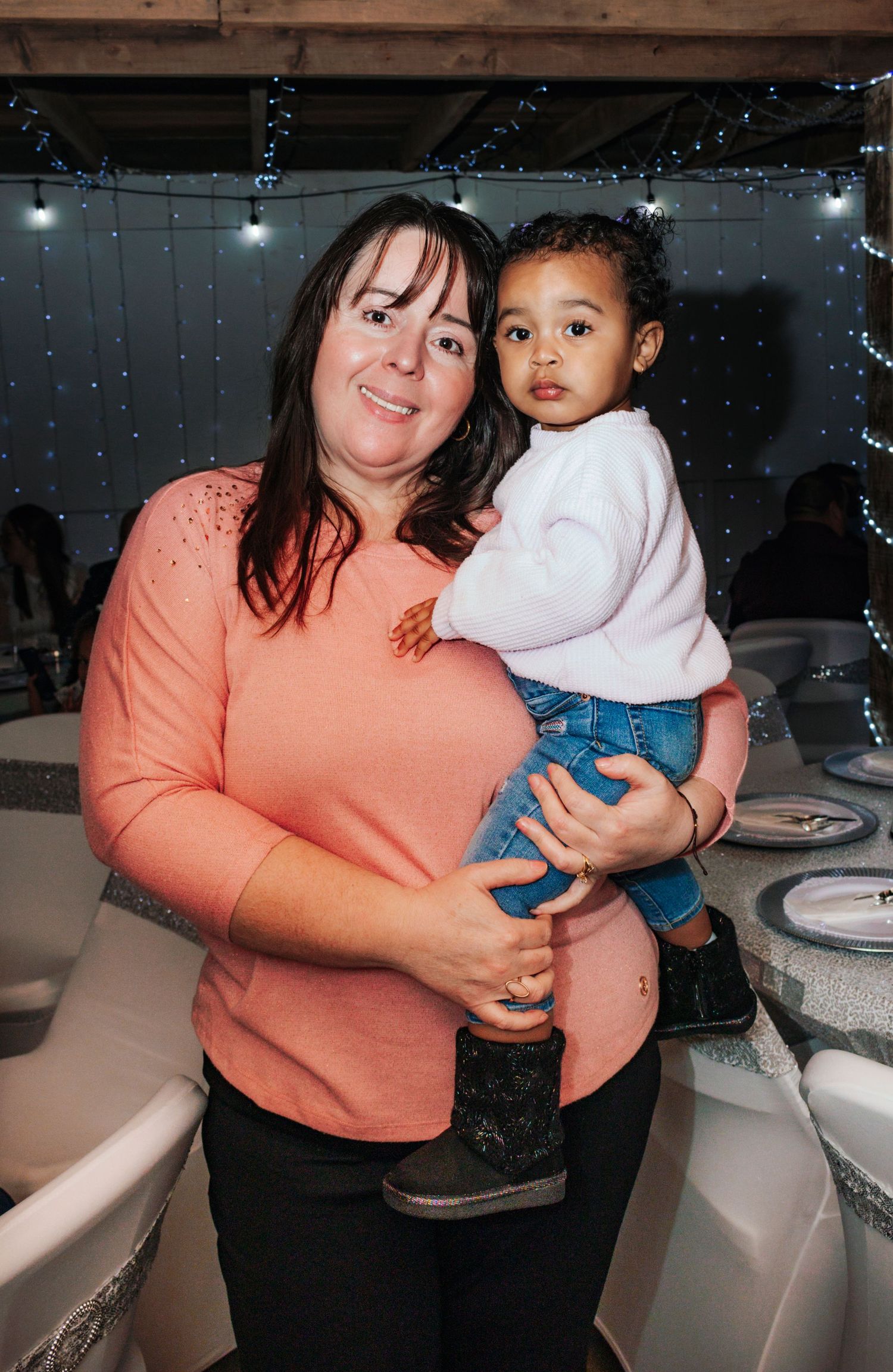 A sequence of photos showing a woman in a peach sweater holding a small child near a bathroom counter.