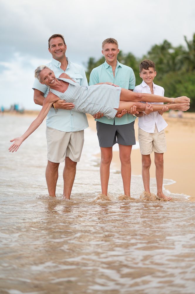 Family carrying mom at playa azul Luquillo Puerto Rico