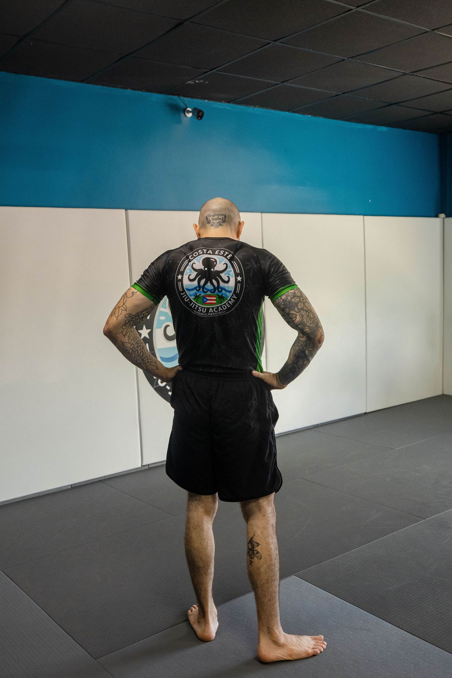Brazilian Jiu Jitsu student posing in front of Costa Este BJJ academy wall in Luquillo, Puerto Rico”