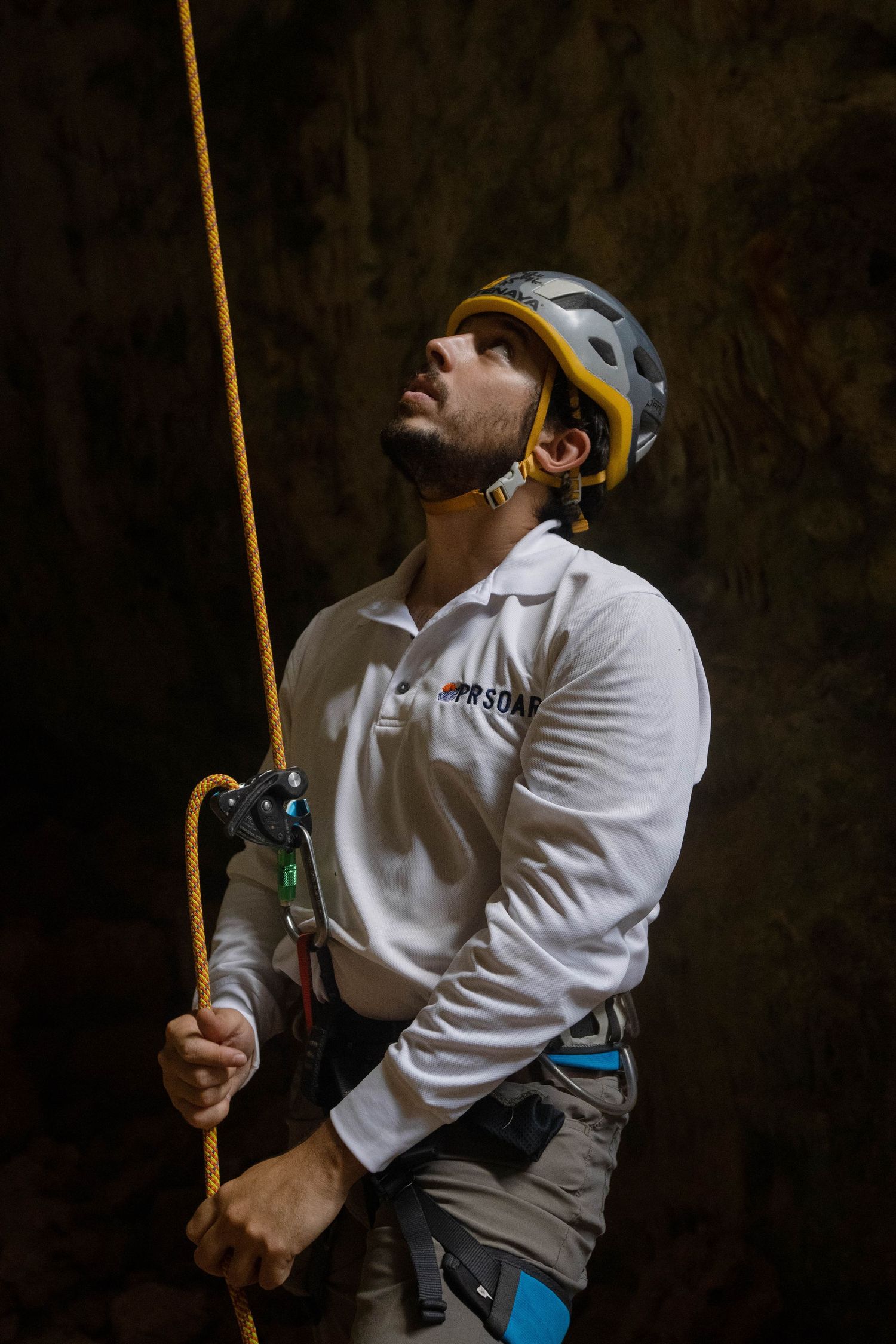 Belayer watching climber ascending with rope system at PRSOAR in Monagas Park, Bayamón Puerto Rico