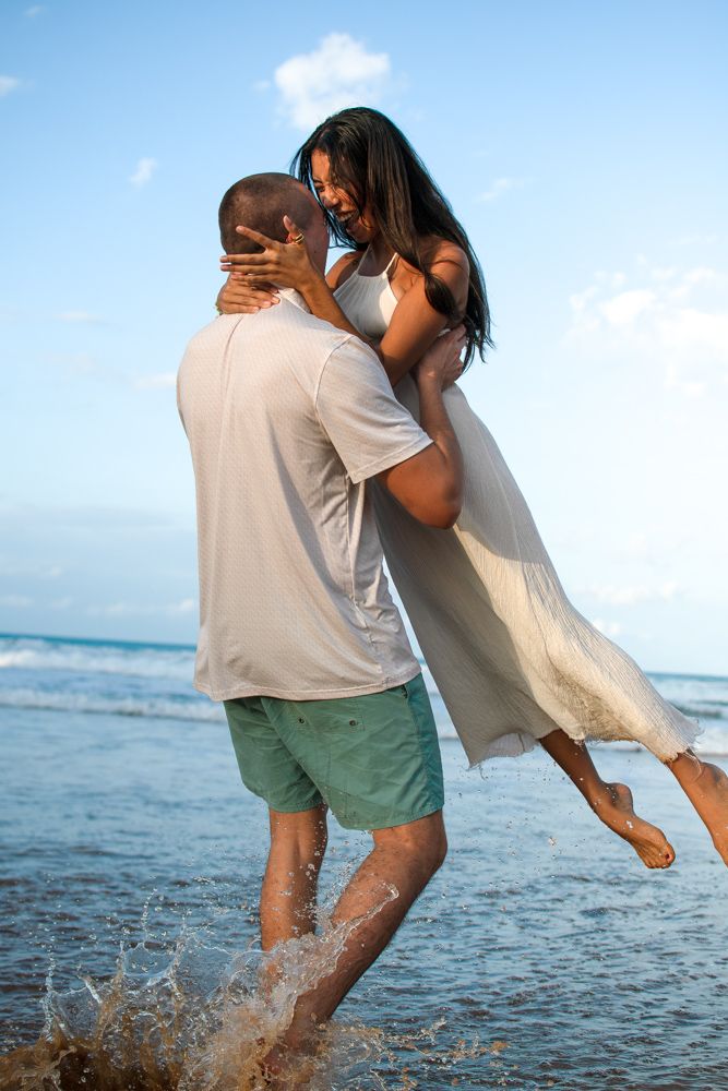 Engaged couple celebrating on La Pared beach in Luquillo Puerto Rico during sunset photoshoot