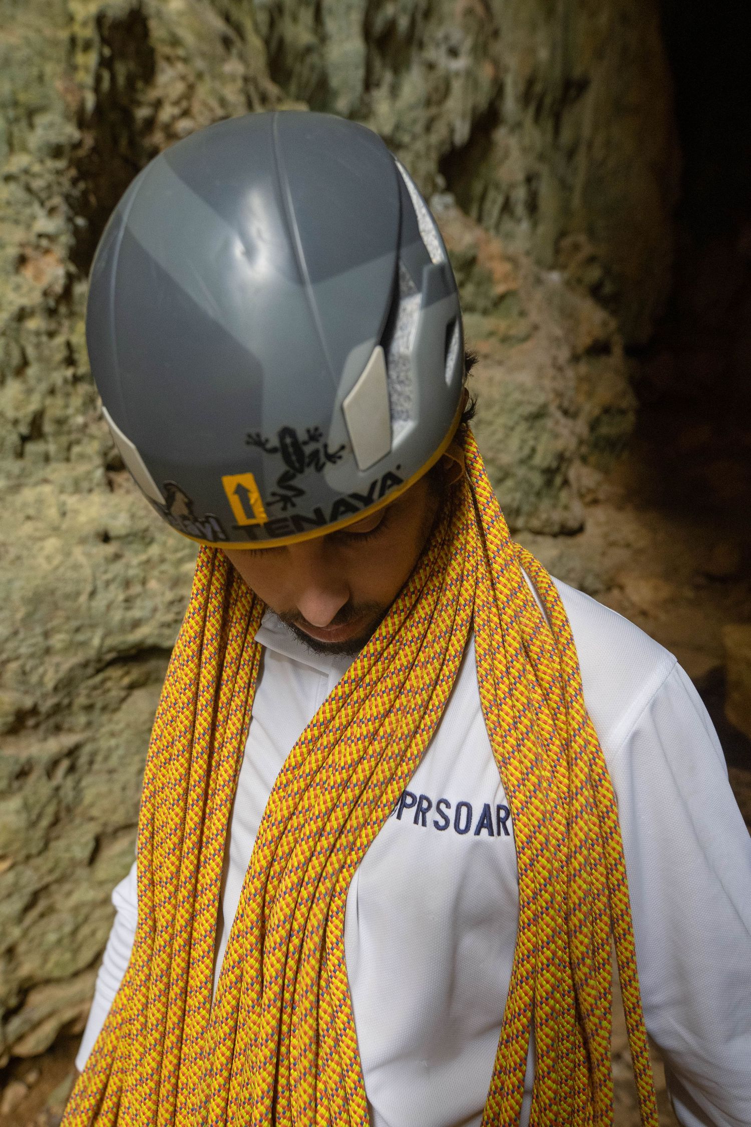 Climber wearing helmet and harness preparing rope system at PRSOAR Monagas Park, Bayamón