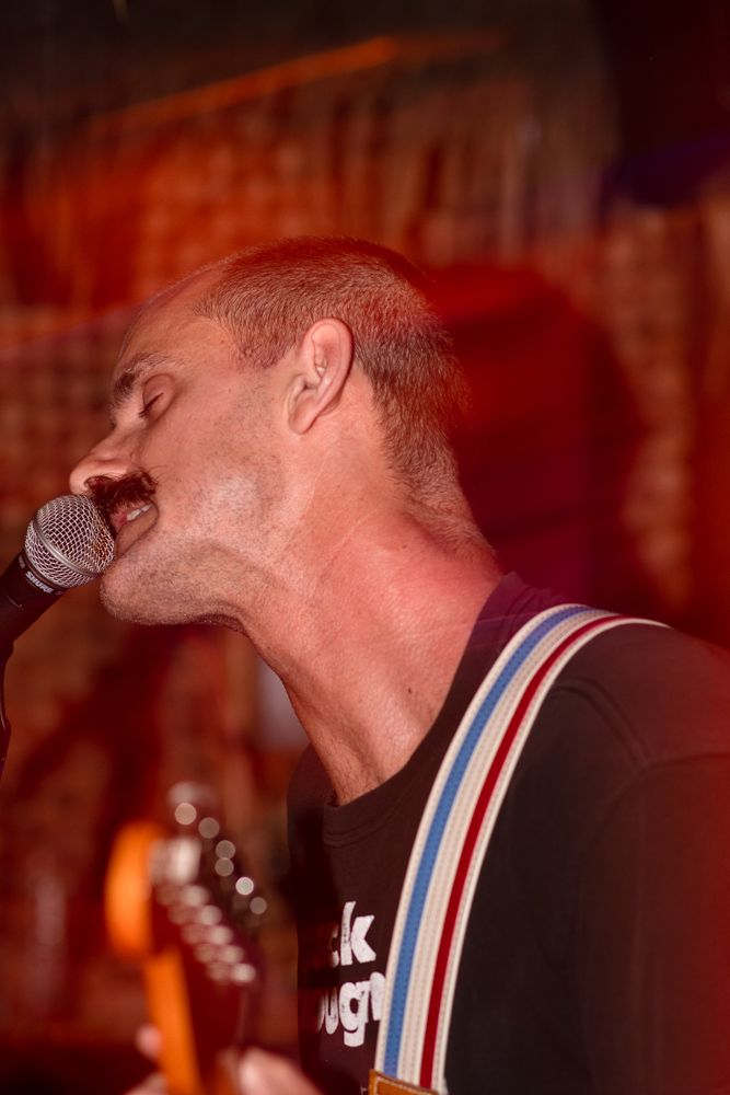 punk band lead singer rocking out in tiki bar Long Beach California