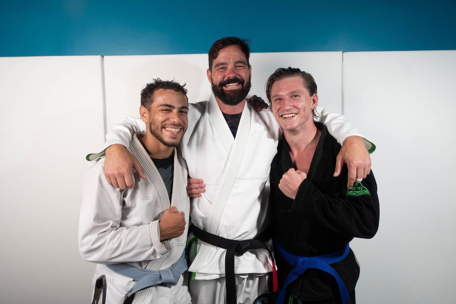 Friends and teammates smiling after Jiu Jitsu training at Costa Este gym in Puerto Rico