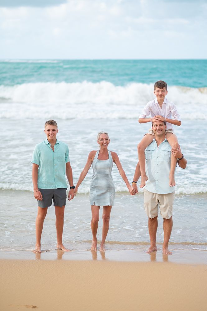 Family walking together along the shoreline at Playa Azul beach in Luquillo Puerto Rico