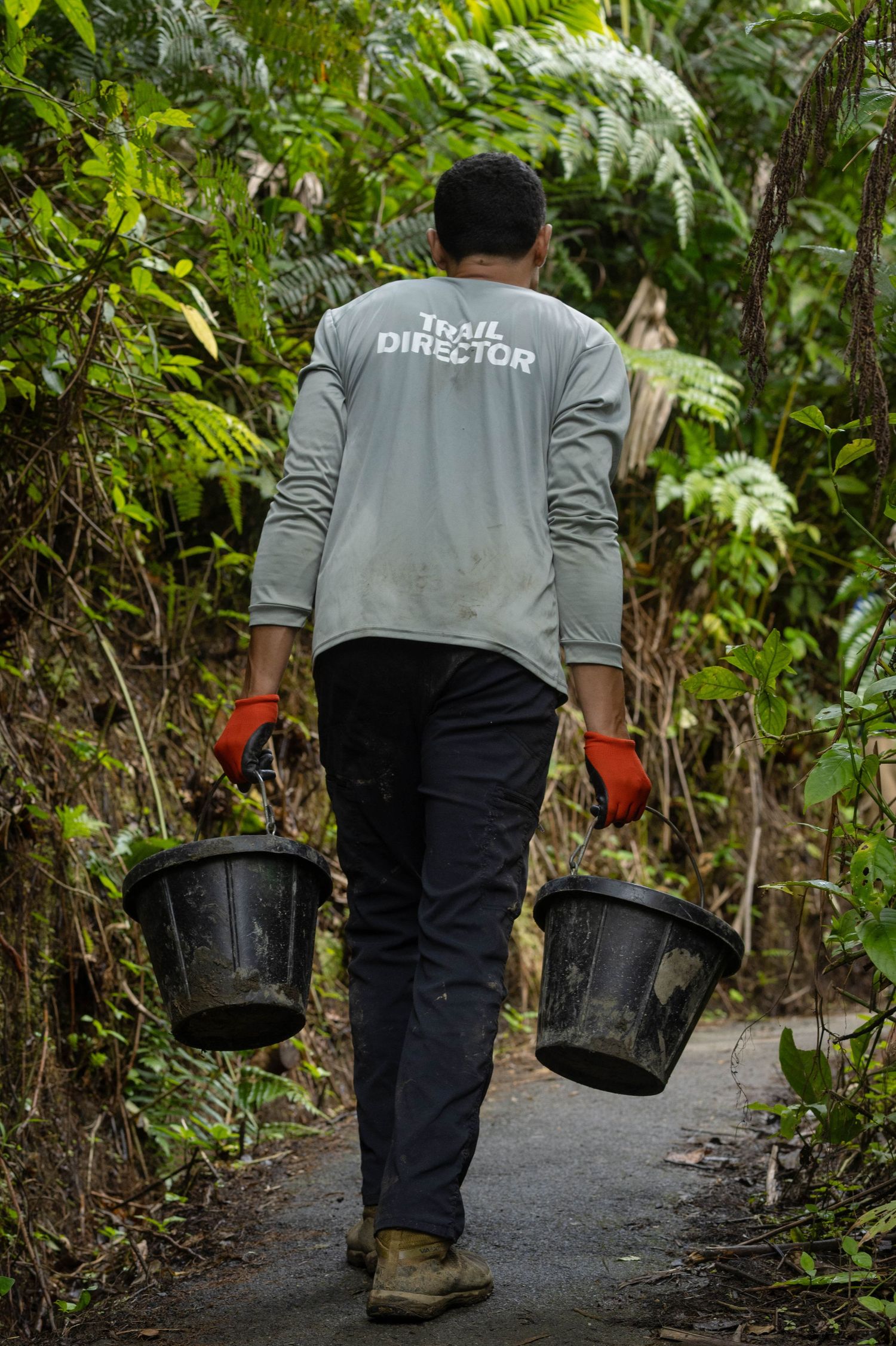 Love in motion Trail director carrying buckets of gravel to maintain trail
