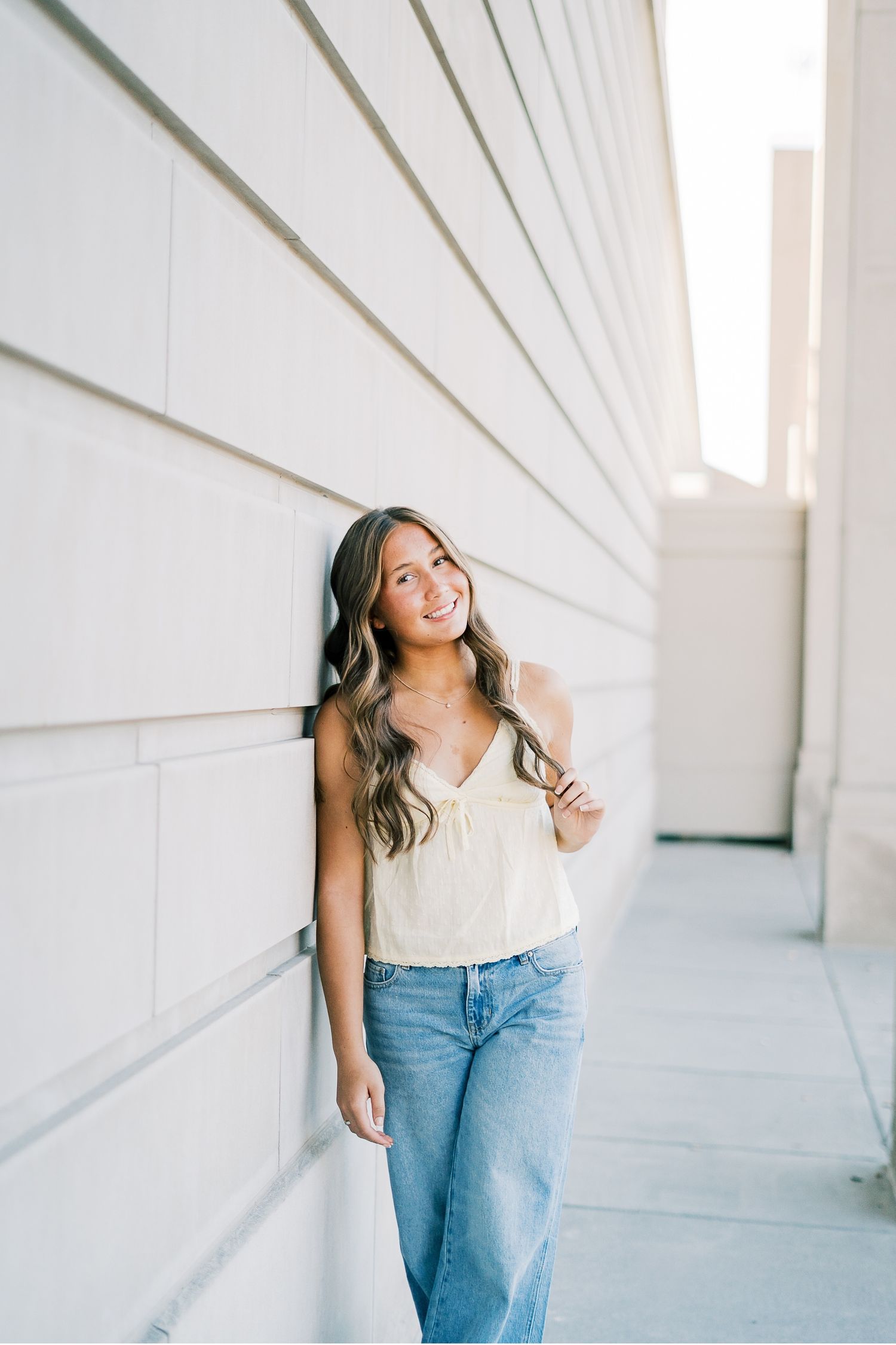 A sequence of casual lifestyle portraits against a white architectural wall in natural lighting.