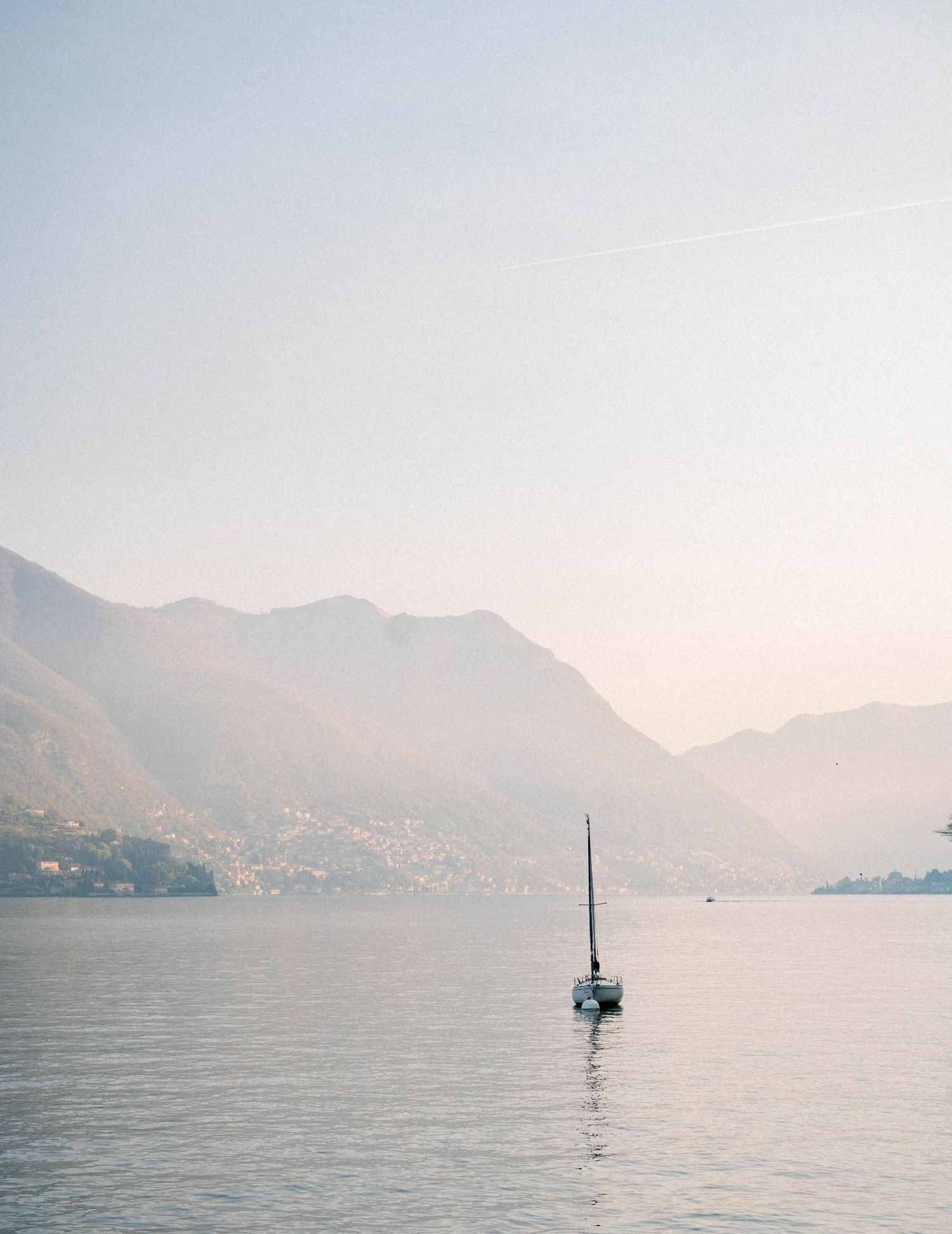 Serene mountain lake landscape with misty peaks and calm waters in multiple perspectives.