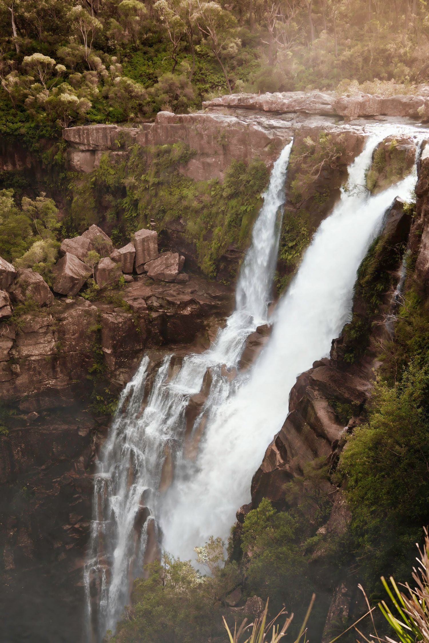 A series of scenic waterfall images showing cascading white water flowing over rocky cliffs in a lush forest setting.