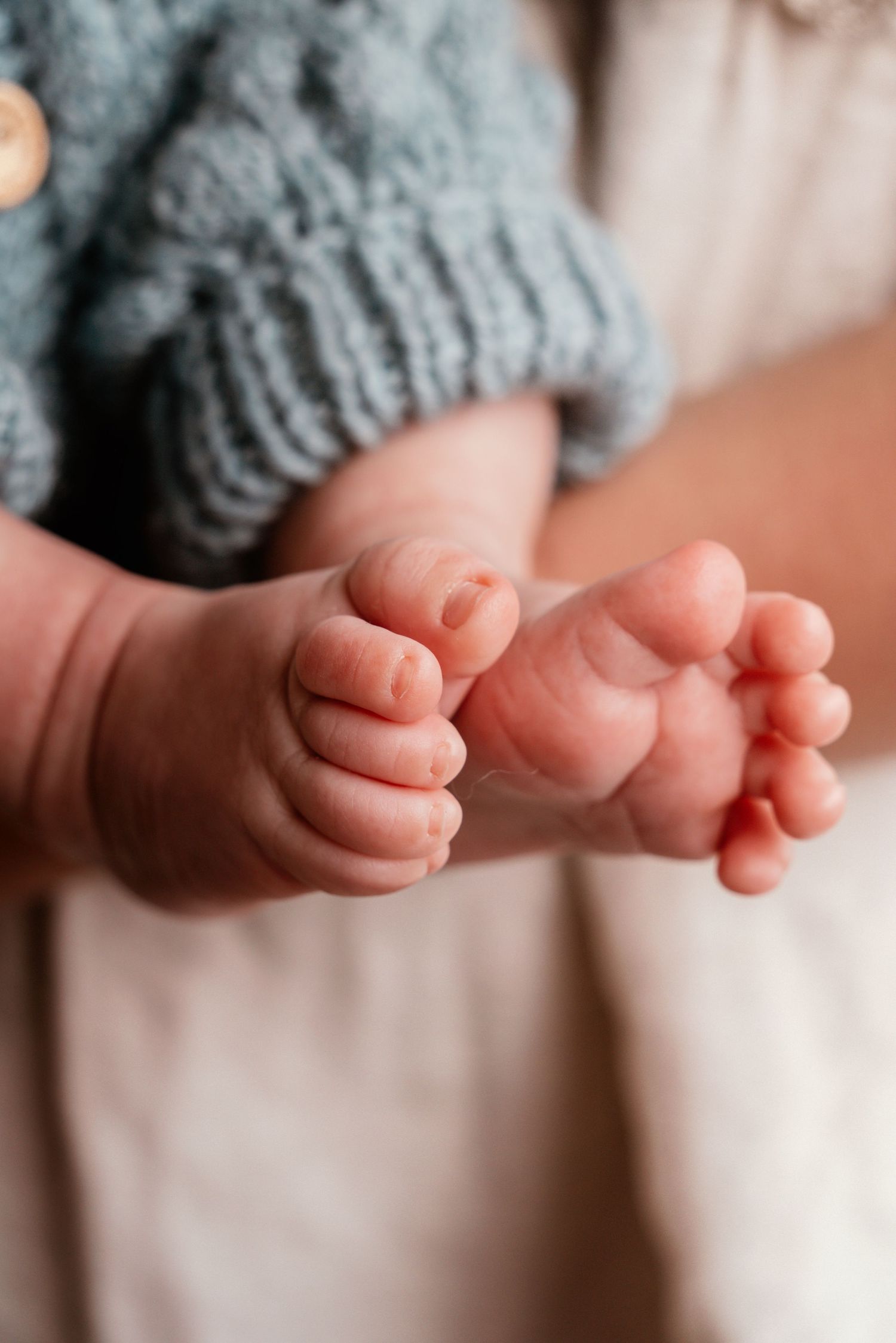 Close-up series of tiny newborn baby toes and feet against a soft blurred background.