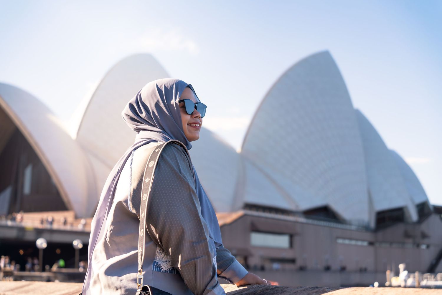 A series of architectural photos showing different angles of the iconic Sydney Opera House in Australia.